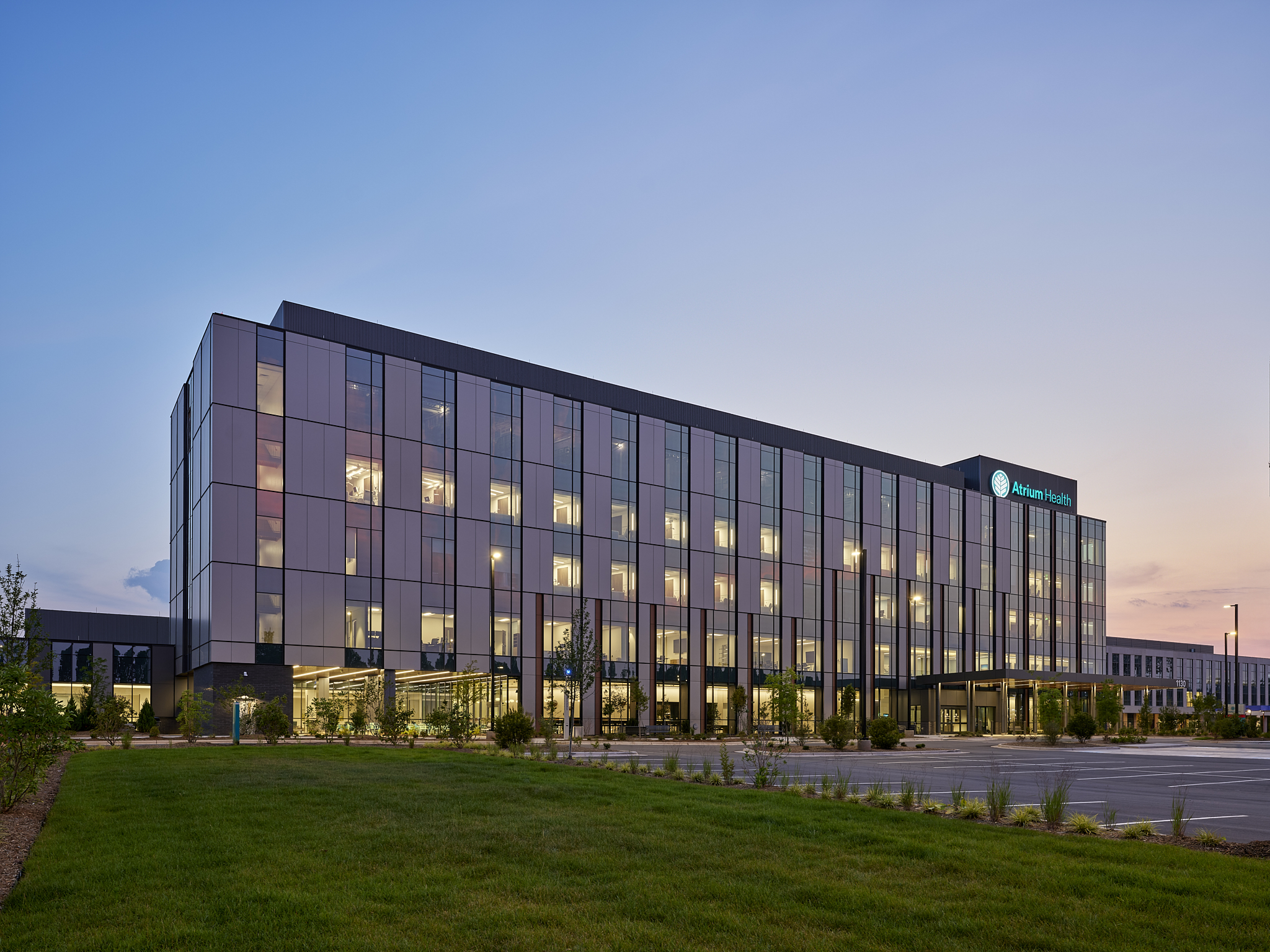 Lake Norman Hospital Main Exterior metal facade against a sunset, the new hospital features evidence based design and cutting edge technology. The Hospital is designed by NBBJ Architects and captured by architectural photographer, Nick McGinn of McGi