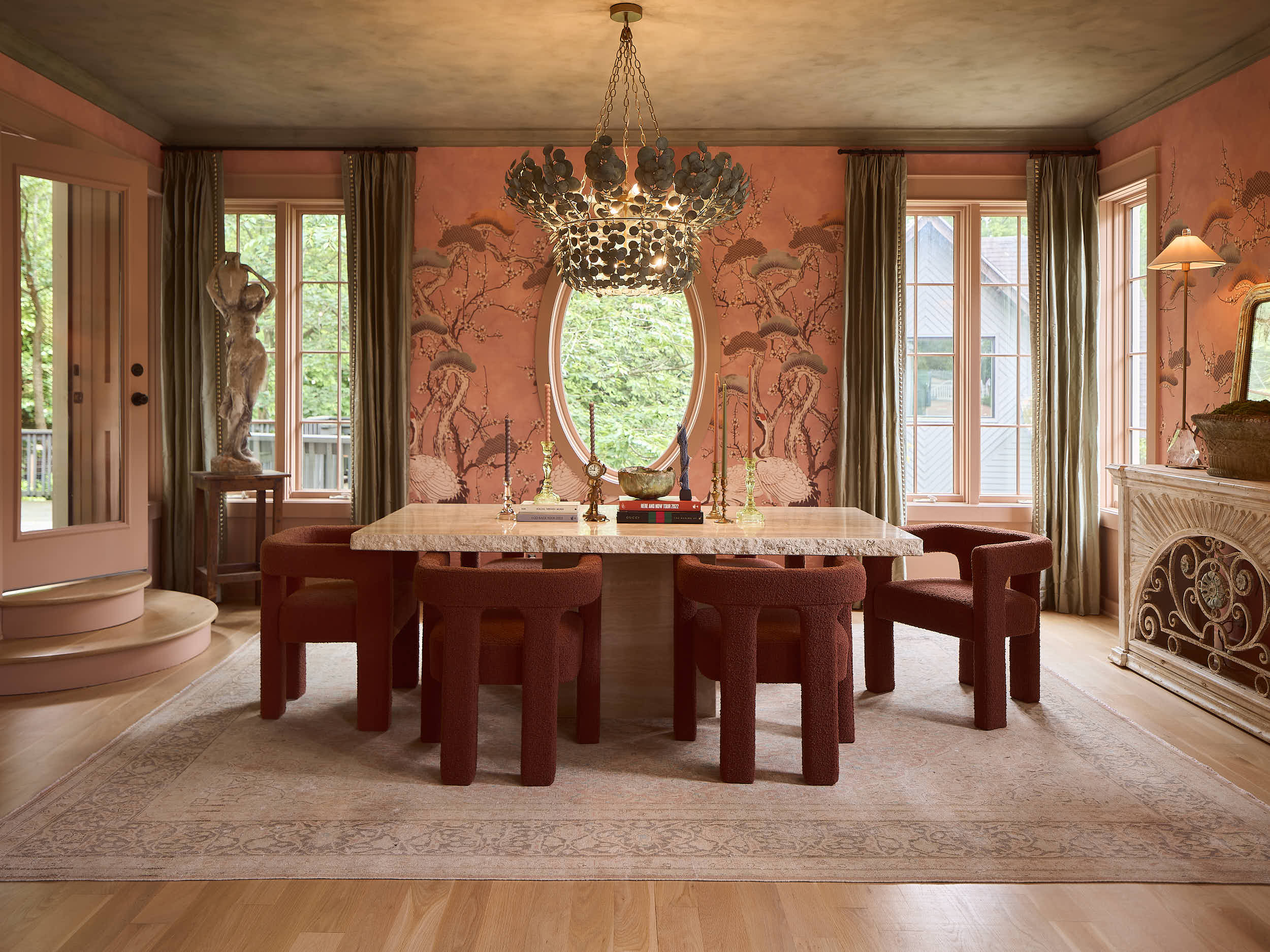 Capturing this private celebrity residence in Nashville, TN, was a study in rich texture and sophisticated color. This stunning dining room, designed by Branan White Interior Design, features custom terracotta crane-motif wallpaper and a dramatic, br
