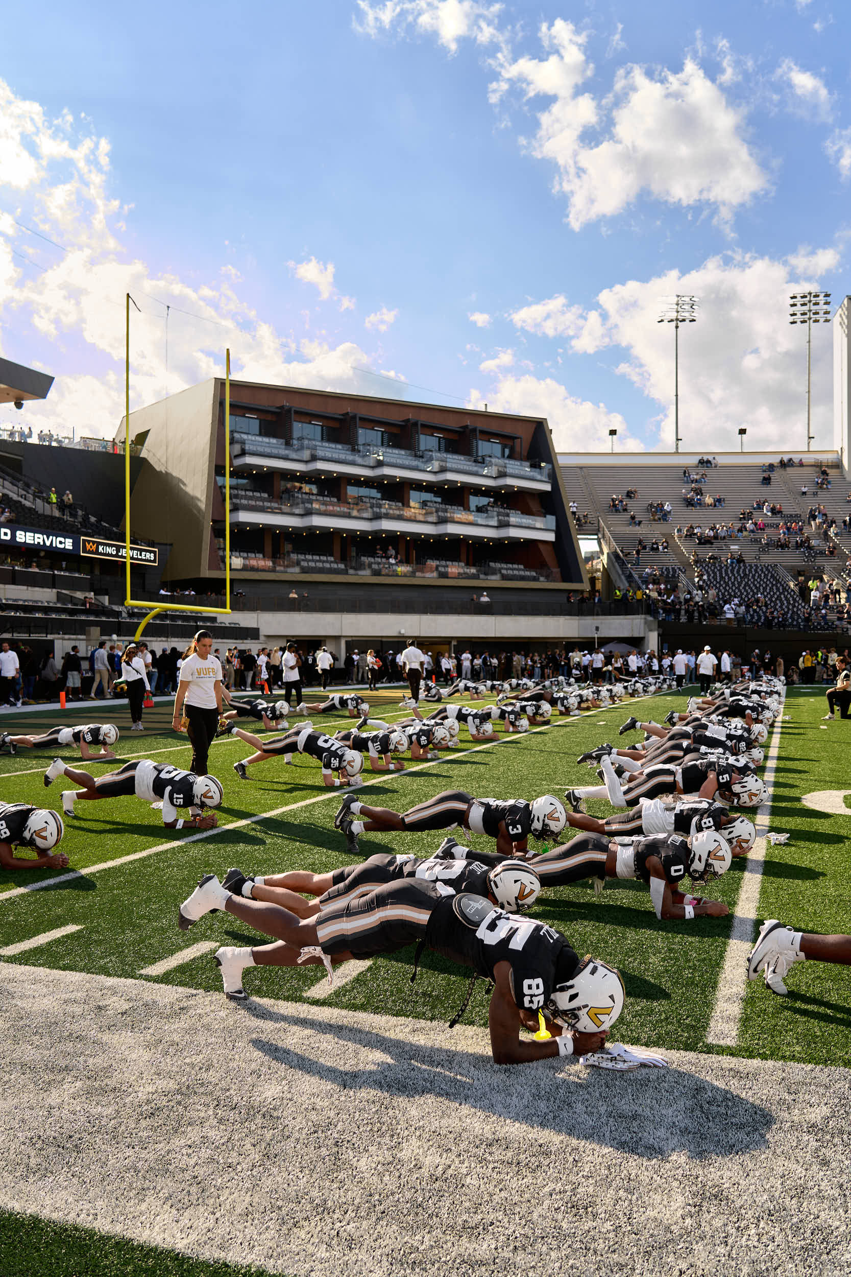Professional architectural photography of the Vanderbilt FirstBank Stadium South End Zone expansion. Highlights include the Frist Athletics Village, Commodore Suites, and modern SEC stadium design by Populous and Barton Malow