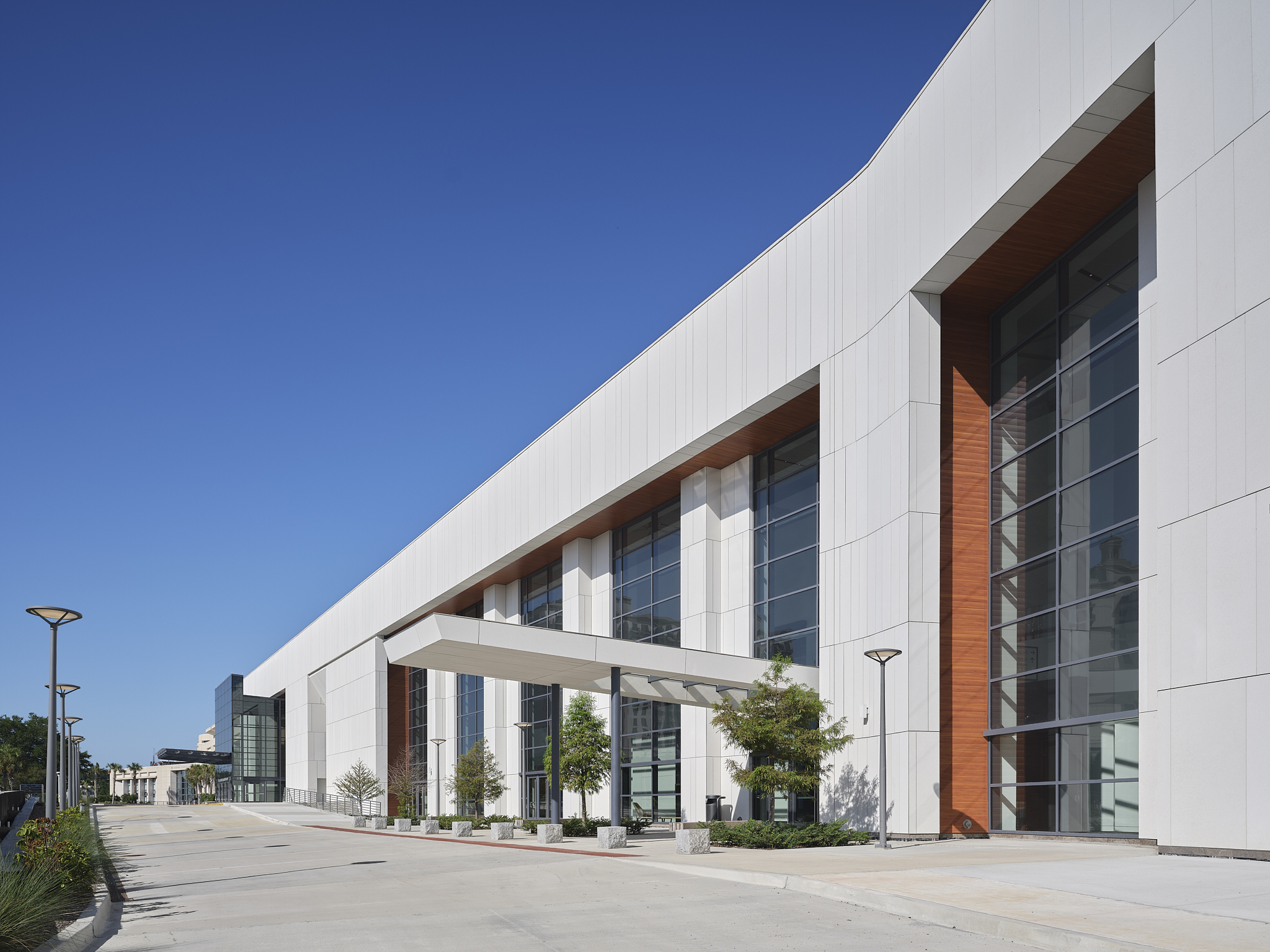 A wide-angle exterior architectural photograph of the Savannah Convention Center expansion, showing the loading entrance