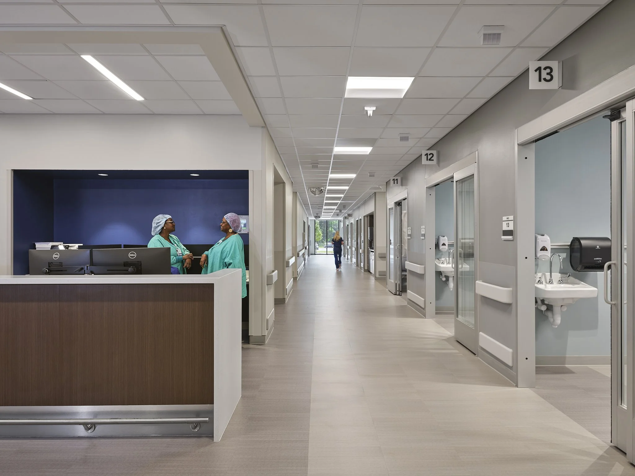 Lake Norman Hospital Nursing Station with patient rooms, featuring evidence based design and cutting edge technology. The Hospital is designed by NBBJ Architects and captured by architectural photographer, Nick McGinn of McGinn Photography