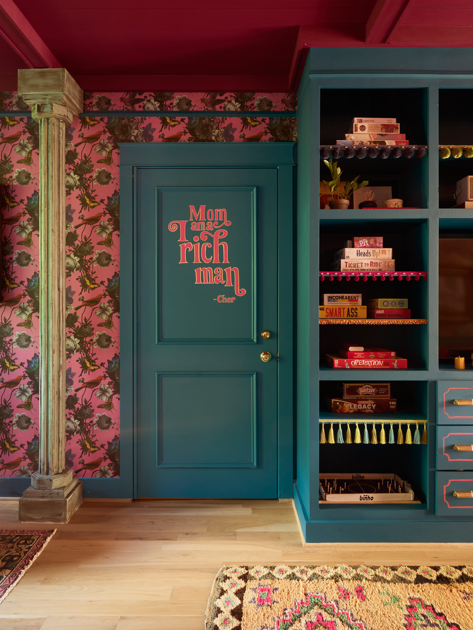 Capturing the intricate details of this bespoke Nashville interior. This project by Branan White Interior Design showcases expert color-blocking with deep teal and bold berry tones. The custom millwork and built-in shelving are meticulously styled, f