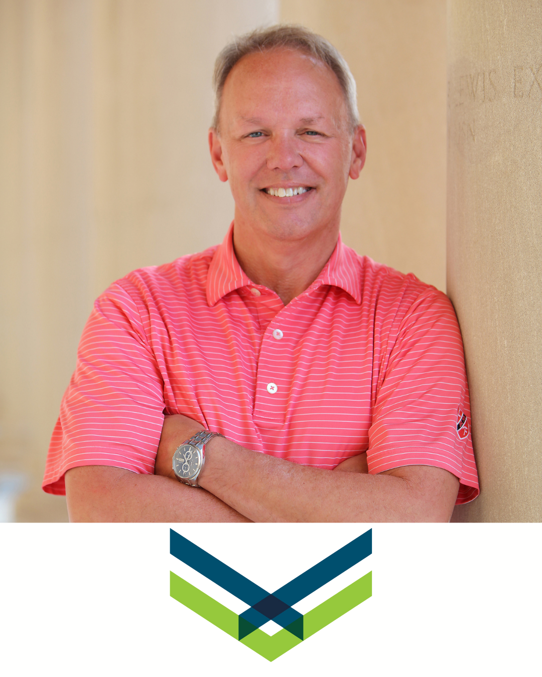 A man with short light hair and a tan complexion wearing a pink striped polo shirt, smiling with arms crossed, leaning against a beige wall, with a logo featuring overlapping chevrons in blue and green below the image.