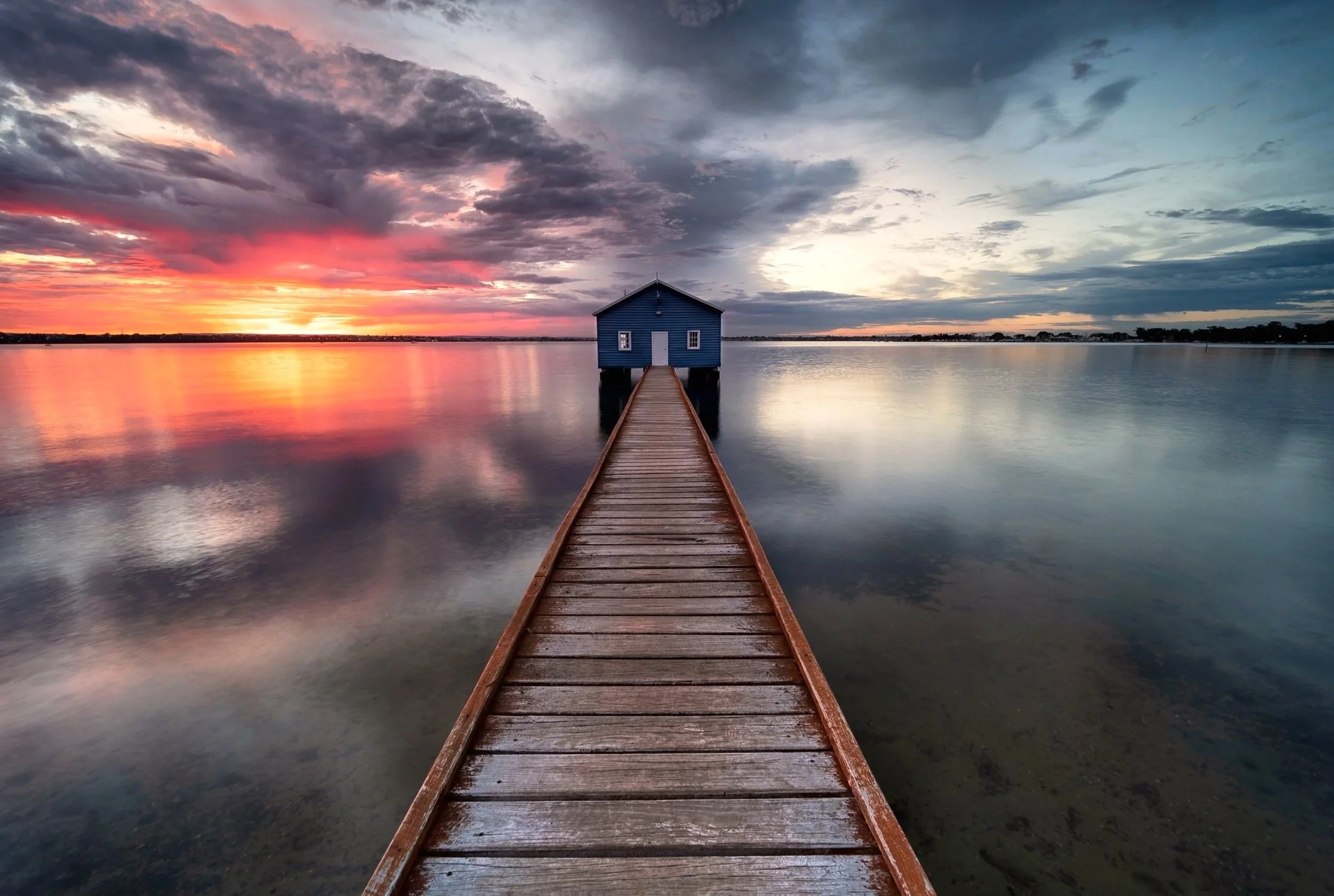 The famous Blue Boatshed at sunrise with clouds reflecting on the Swan River