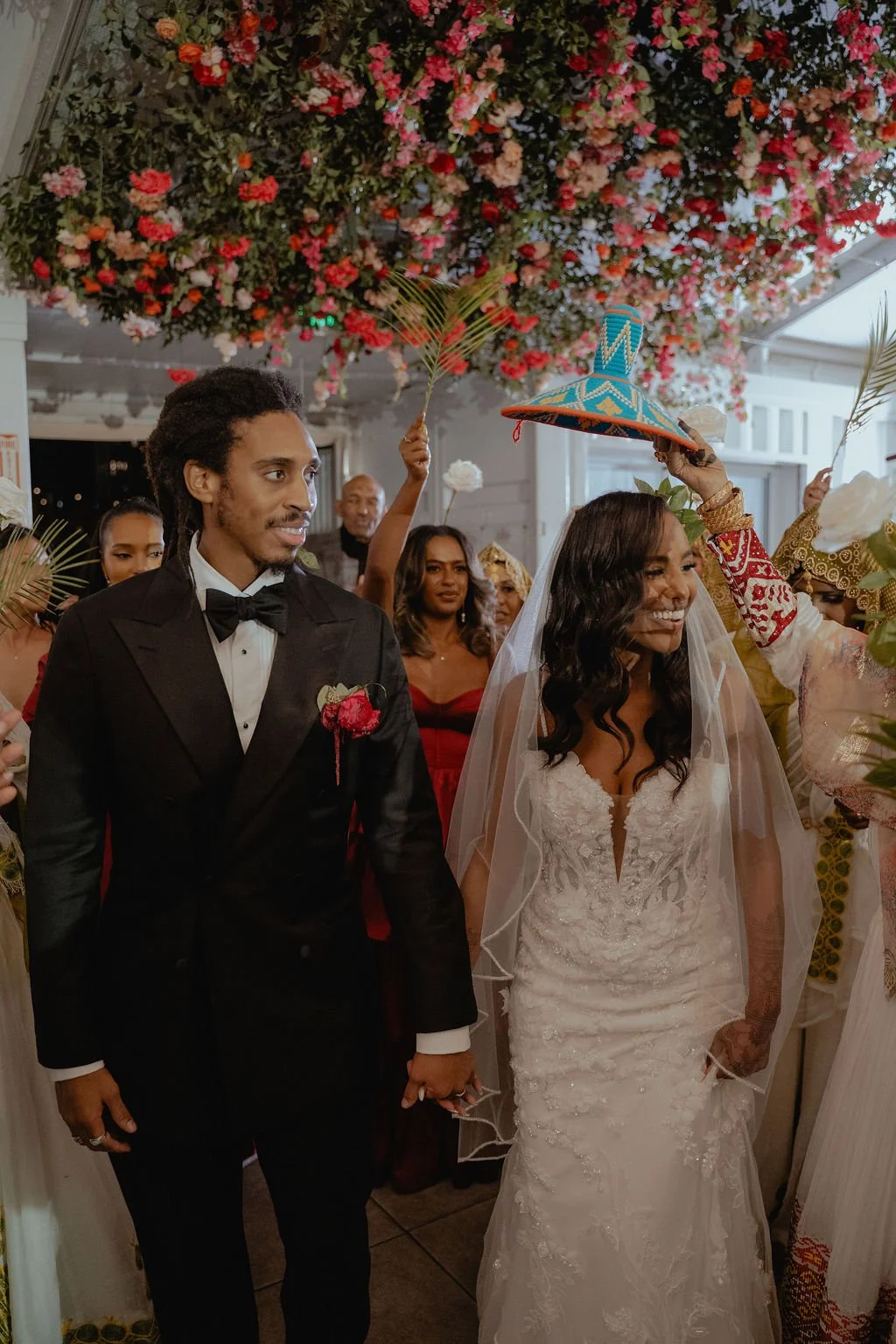 Bold Skyline Events SF wedding with rich deep raspberry, olive green, orange, burgundy, and pink wedding flowers. Featuring striking bridal and bridesmaid bouquets, ceremony florals, colorful reception centerpieces, lush aisle arrangements, and premi