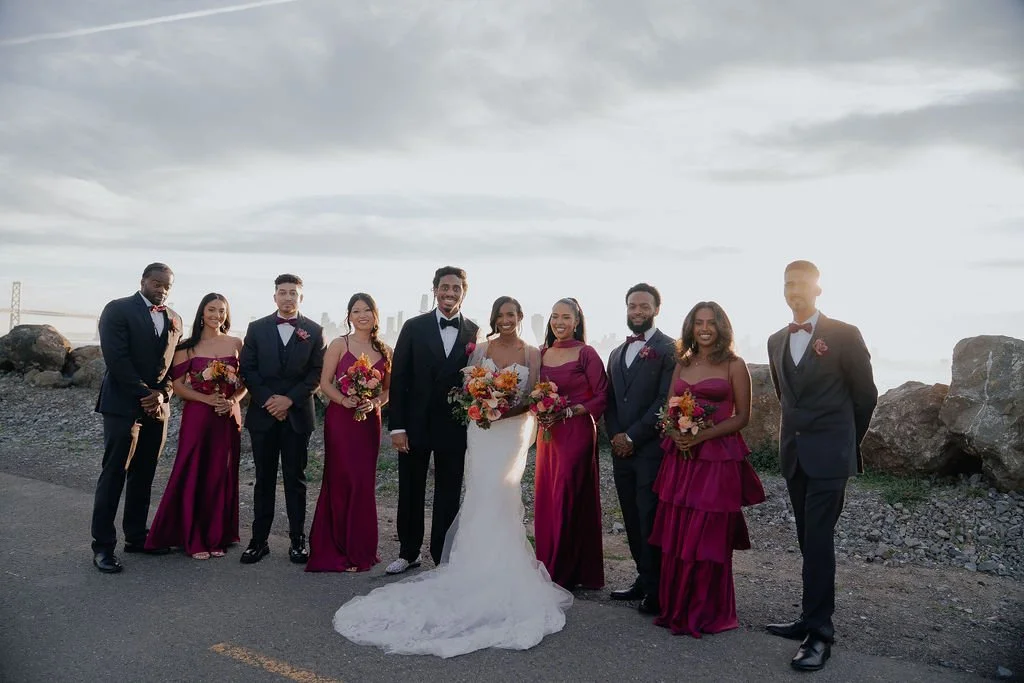 Bold Skyline Events SF wedding with rich deep raspberry, olive green, orange, burgundy, and pink wedding flowers. Featuring striking bridal and bridesmaid bouquets, ceremony florals, colorful reception centerpieces, lush aisle arrangements, and premi