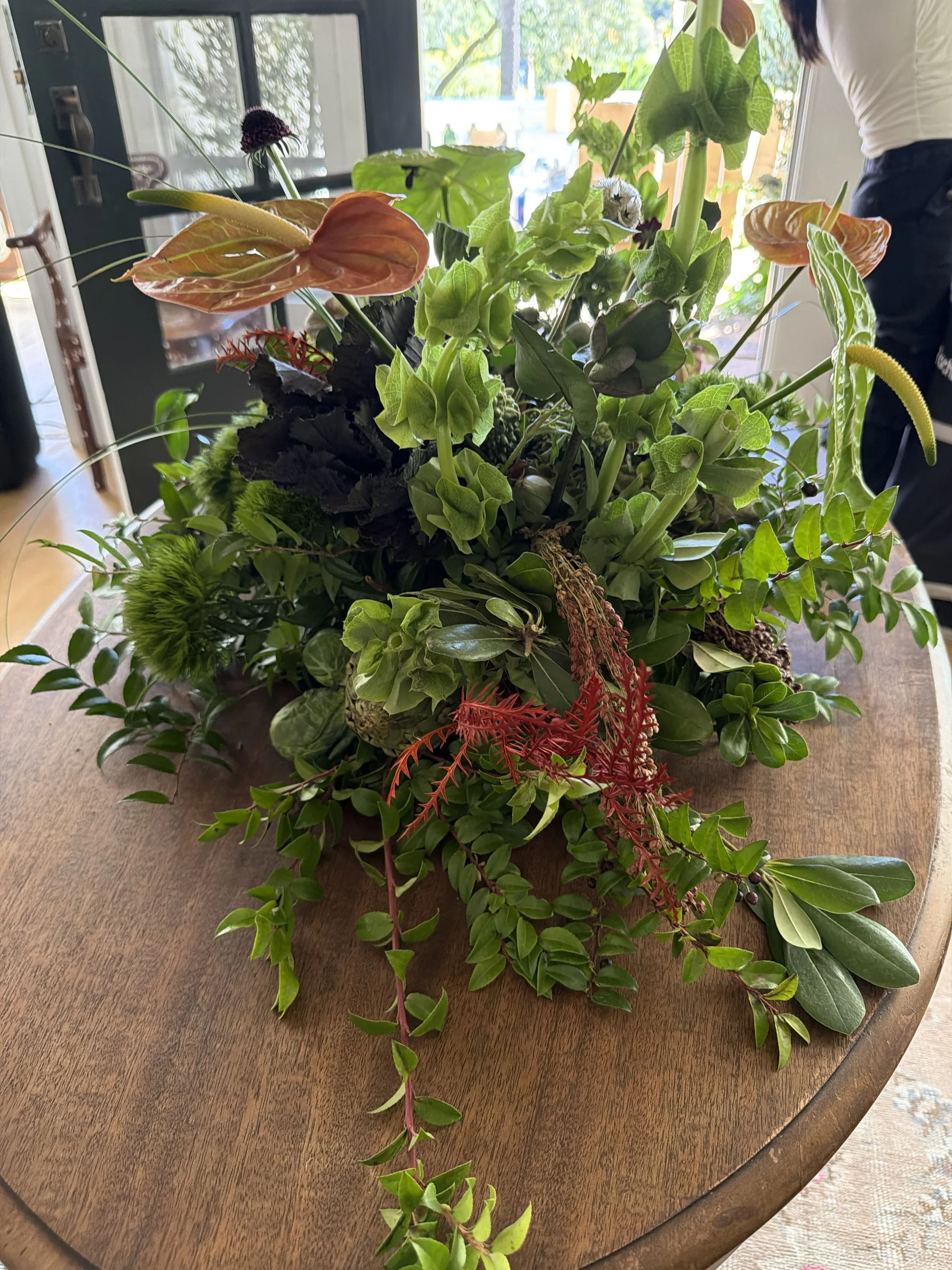Contemporary corporate event floral design for Methodology, featuring artistic, sculptural arrangements with lush greenery, premium blooms, and unexpected botanical elements. A modern, organic, garden-inspired approach to corporate event florals in S
