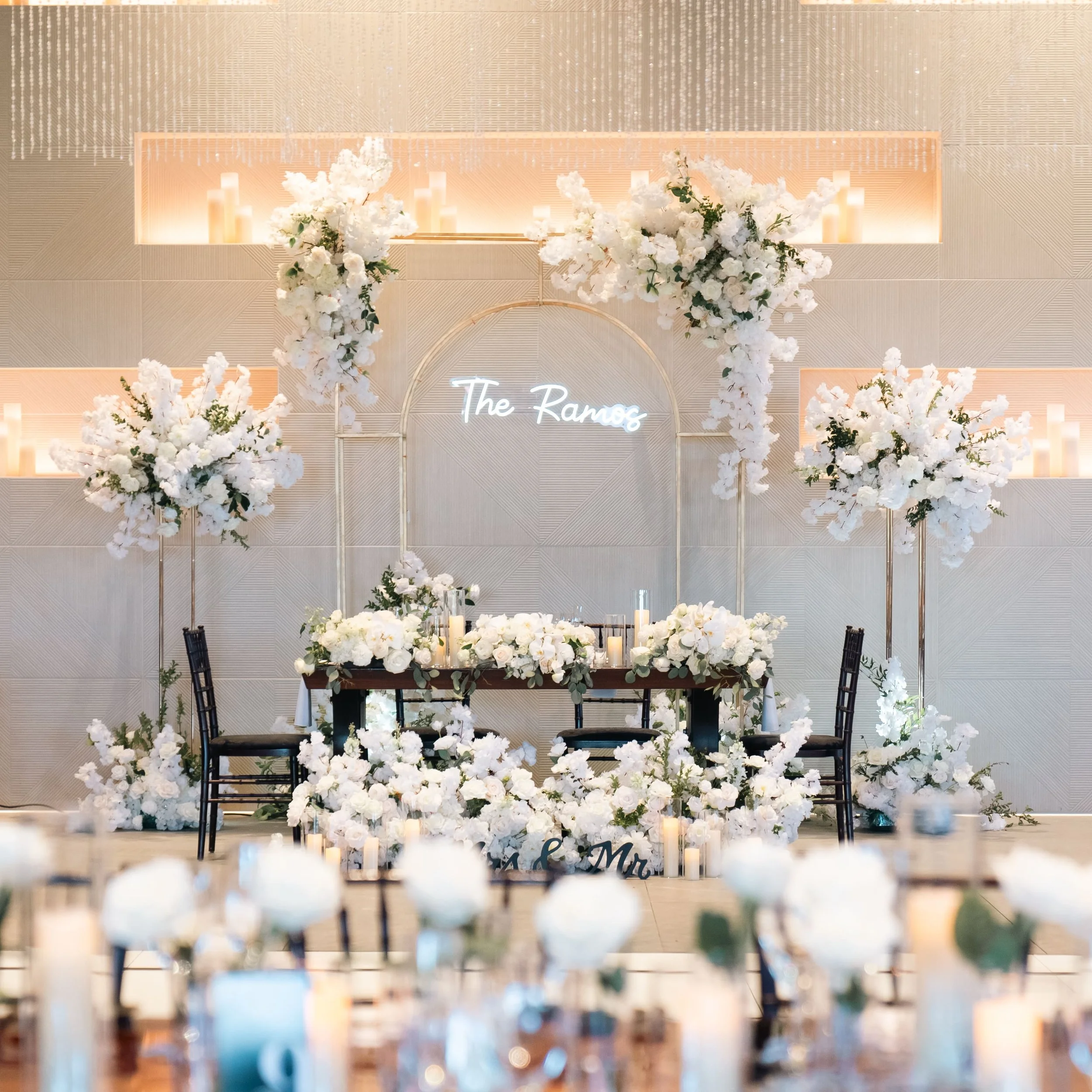 Lush white floral arrangements paired with glowing candles created a romantic, timeless setting for Erika & Javier’s wedding at Palm Event Center. Each bouquet and centerpiece was designed to reflect the couple’s classic style while enhancing the ven