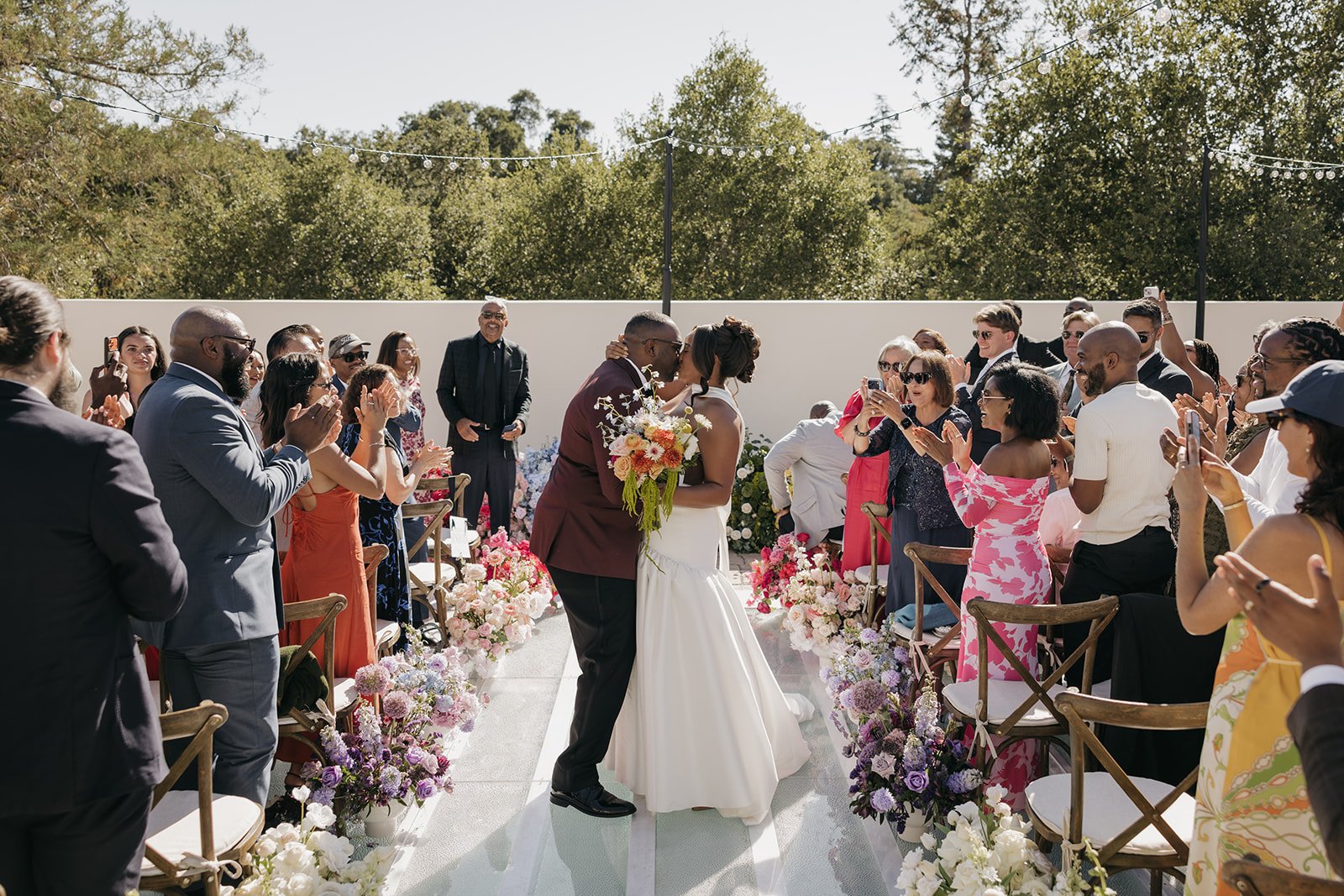 This private residence wedding featured vibrant color-blocking wedding flowers, with each floral arrangement designed in a single bold hue to create a cohesive yet playful aesthetic. From the ceremony to the reception, the custom floral designs trans