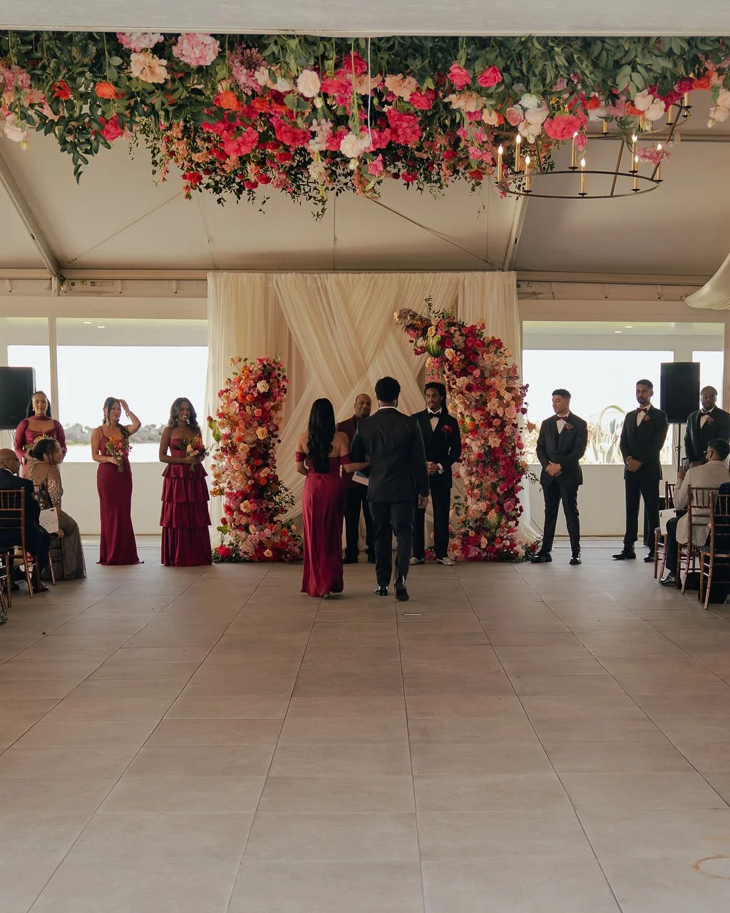 Bold Skyline Events SF wedding with rich deep raspberry, olive green, orange, burgundy, and pink wedding flowers. Featuring striking bridal and bridesmaid bouquets, ceremony florals, colorful reception centerpieces, lush aisle arrangements, and premi
