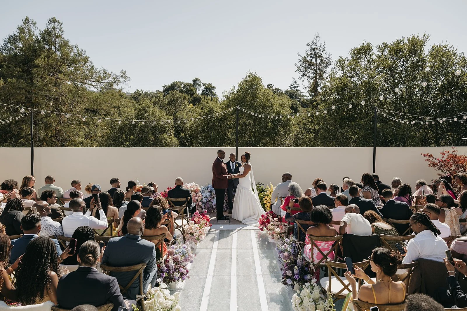 This private residence wedding featured vibrant color-blocking wedding flowers, with each floral arrangement designed in a single bold hue to create a cohesive yet playful aesthetic. From the ceremony to the reception, the custom floral designs trans