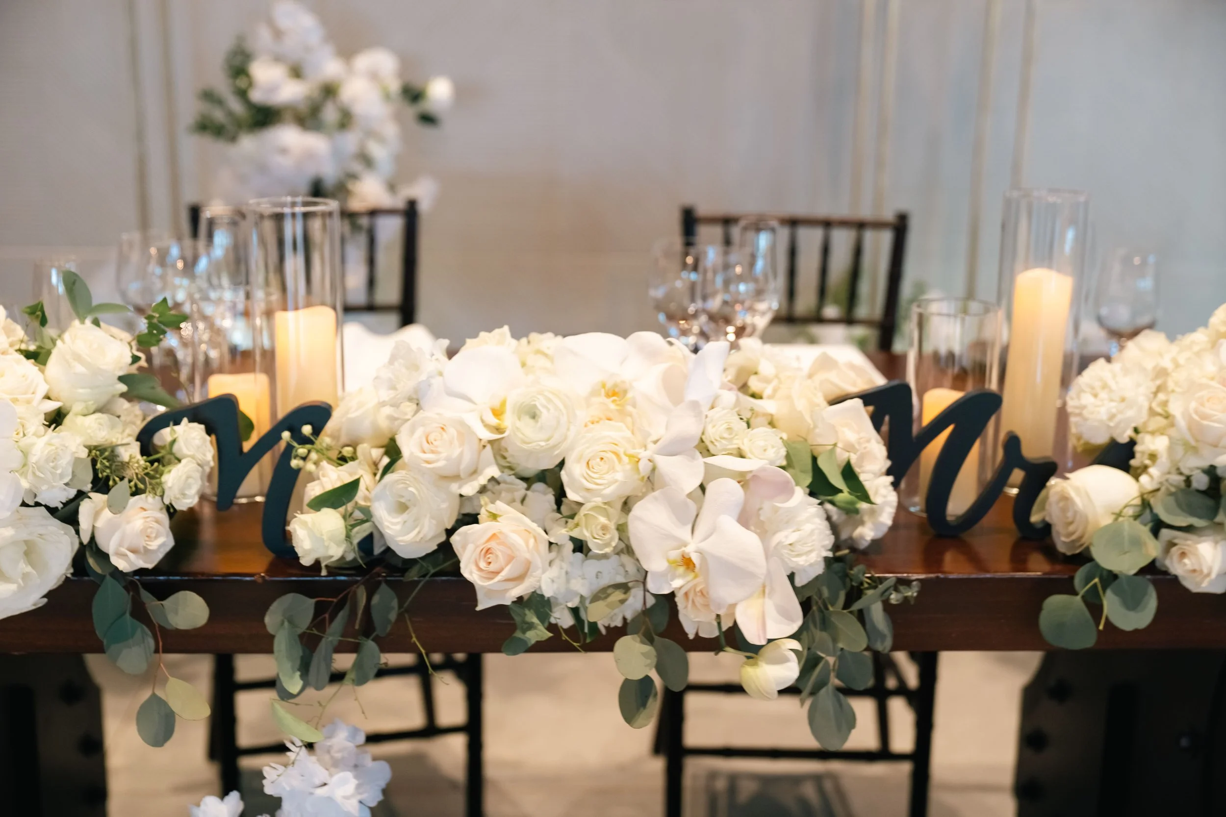 Lush white floral arrangements paired with glowing candles created a romantic, timeless setting for Erika & Javier’s wedding at Palm Event Center. Each bouquet and centerpiece was designed to reflect the couple’s classic style while enhancing the ven