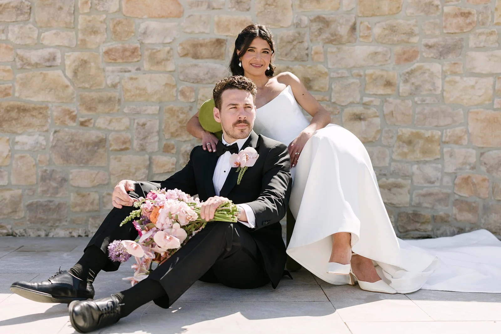 Vibrant Stanly Ranch wedding featuring bold orange, coral, fuchsia, and yellow wedding flowers. Explore lush bridal bouquets, ceremony floral installations, elevated aisle arrangements, and colorful reception centerpieces designed with premium blooms