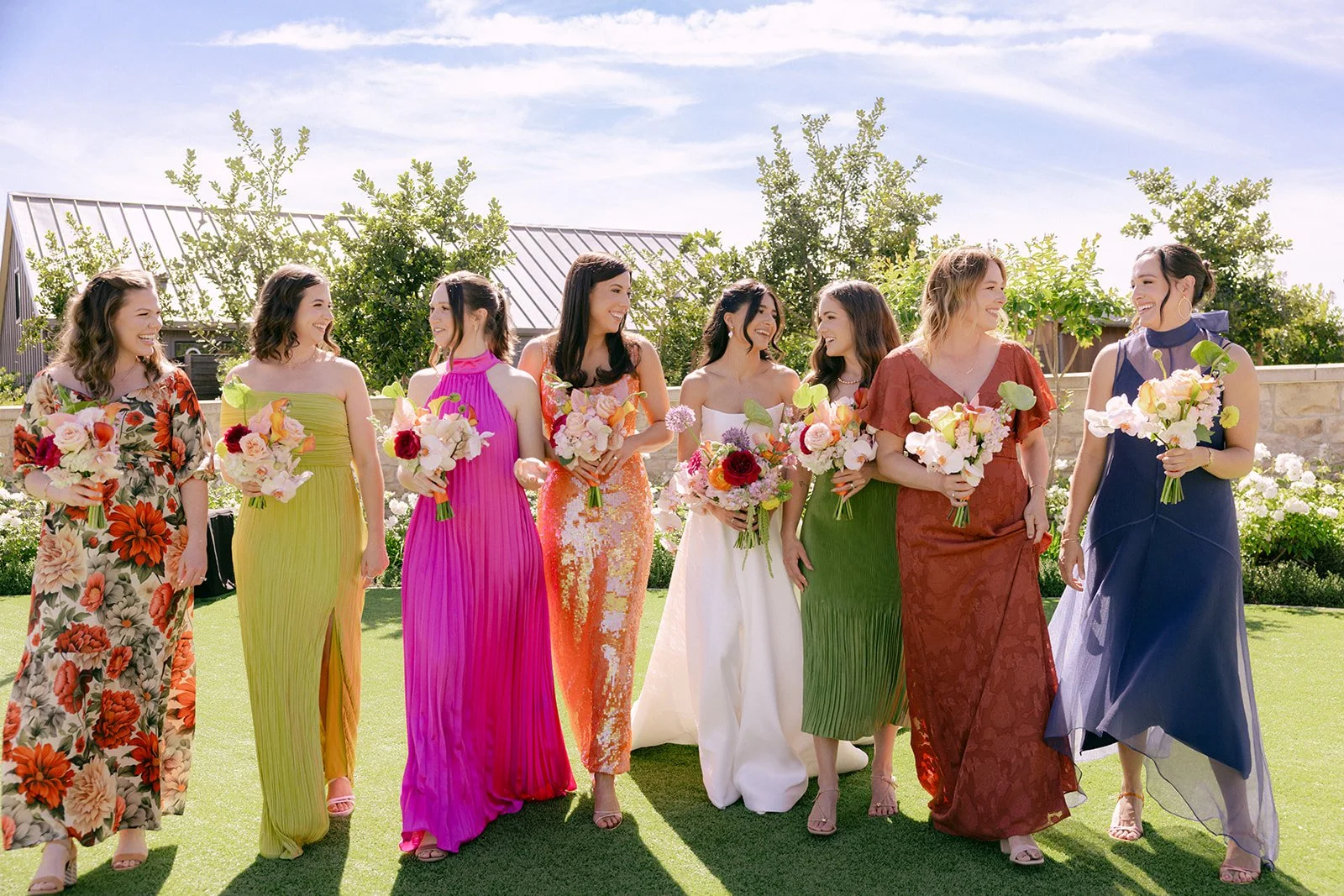 Vibrant Stanly Ranch wedding featuring bold orange, coral, fuchsia, and yellow wedding flowers. Explore lush bridal bouquets, ceremony floral installations, elevated aisle arrangements, and colorful reception centerpieces designed with premium blooms