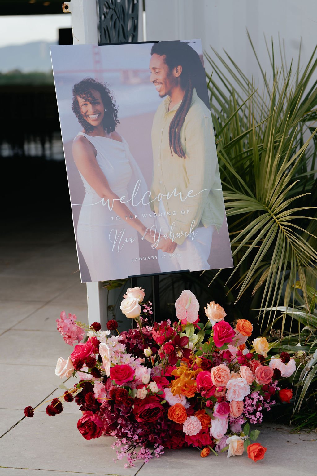 Bold Skyline Events SF wedding with rich deep raspberry, olive green, orange, burgundy, and pink wedding flowers. Featuring striking bridal and bridesmaid bouquets, ceremony florals, colorful reception centerpieces, lush aisle arrangements, and premi