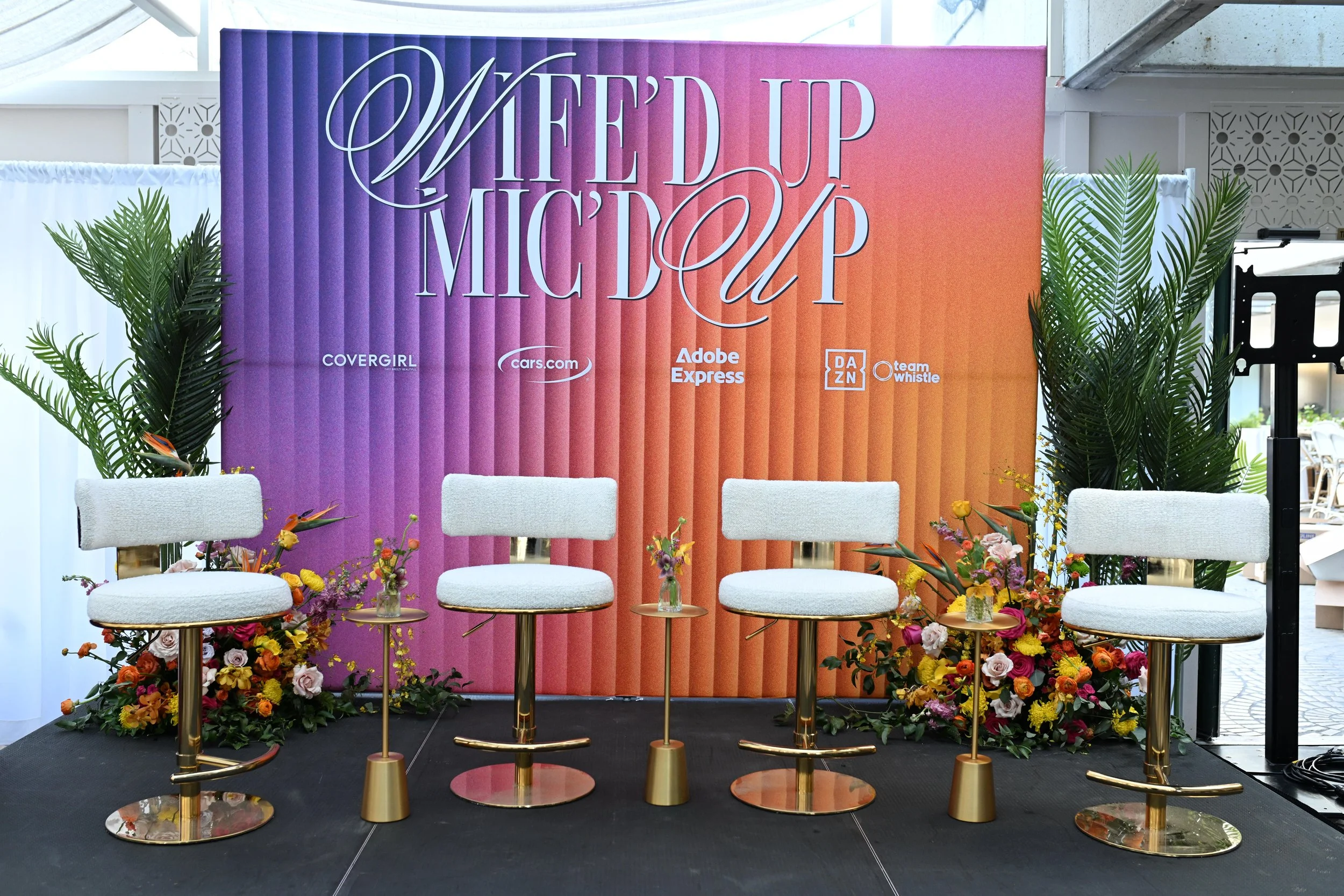 Wife’d Up Mic’d Up launch event with bold orange and purple tropical flowers done by corporate events florist Flowers Valley