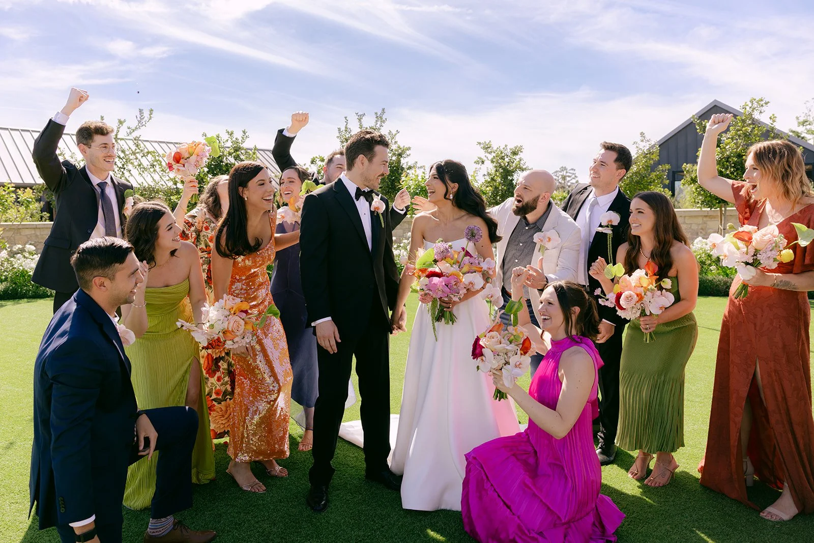 Vibrant Stanly Ranch wedding featuring bold orange, coral, fuchsia, and yellow wedding flowers. Explore lush bridal bouquets, ceremony floral installations, elevated aisle arrangements, and colorful reception centerpieces designed with premium blooms