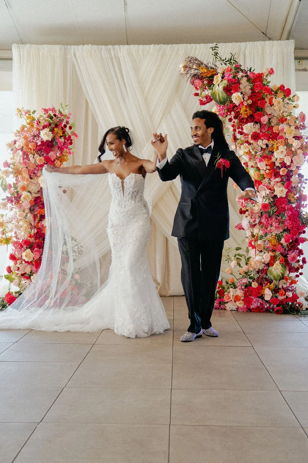 Bold Skyline Events SF wedding with rich deep raspberry, olive green, orange, burgundy, and pink wedding flowers. Featuring striking bridal and bridesmaid bouquets, ceremony florals, colorful reception centerpieces, lush aisle arrangements, and premi