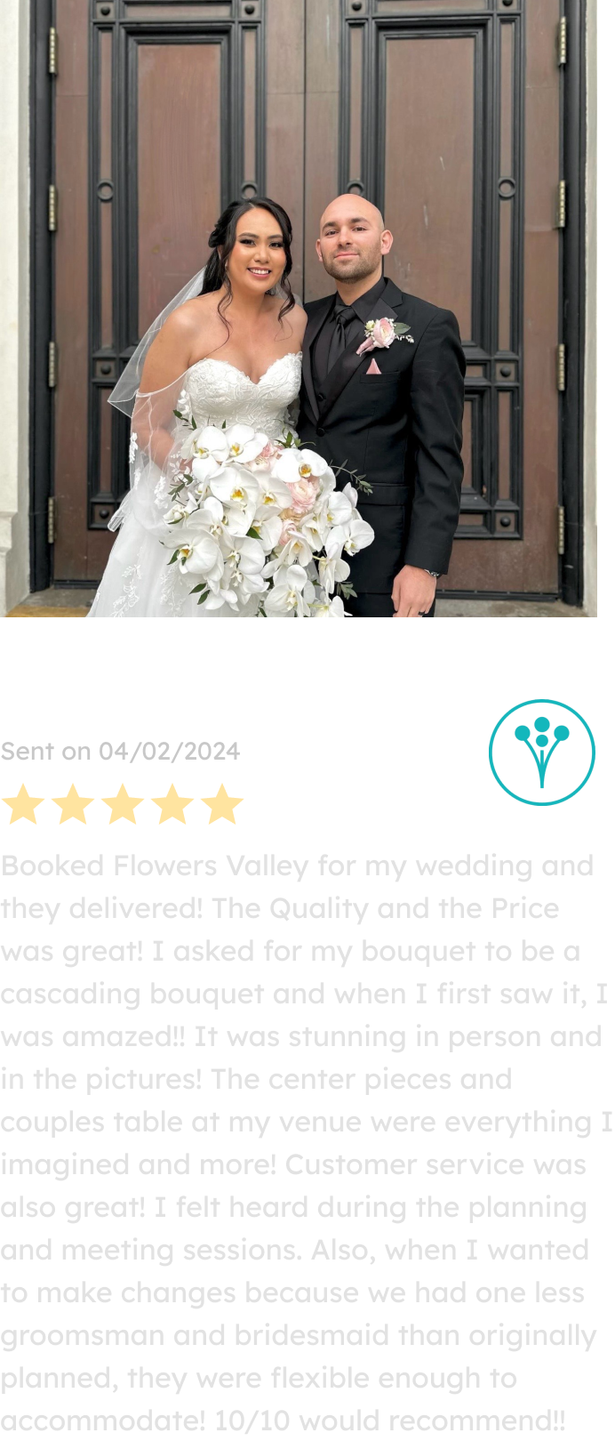A joyful bride holding a stunning cascading bouquet of white orchids and blush roses stands beside her groom in front of elegant wooden doors, featuring floral designs by a San Jose-based florist.