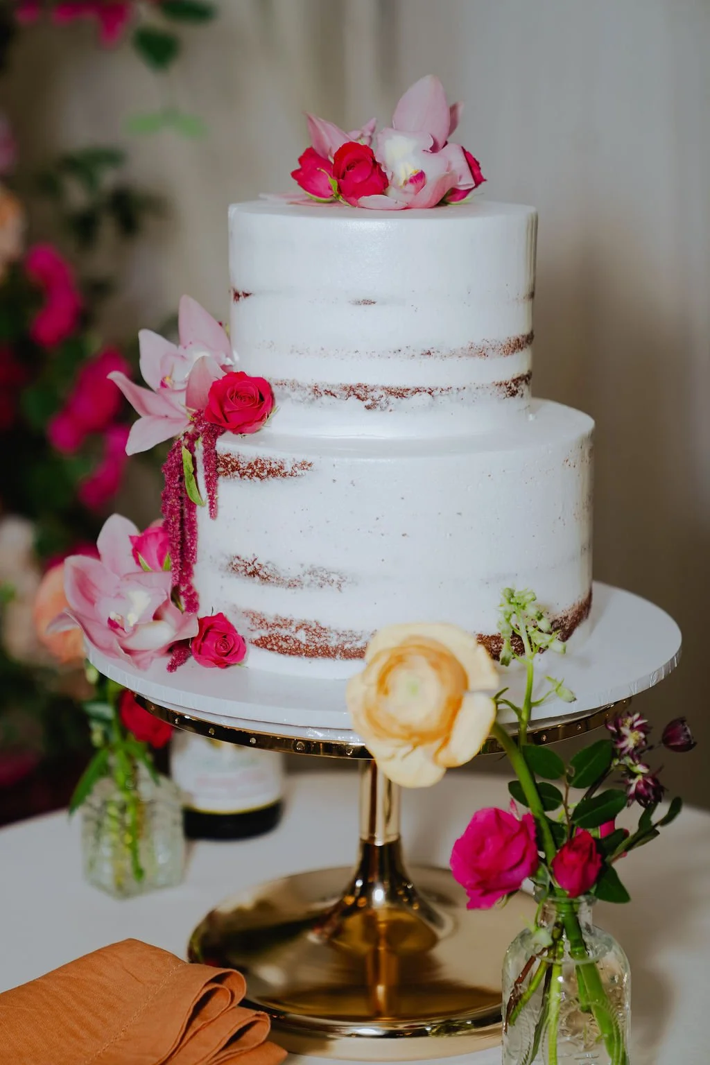 Bold Skyline Events SF wedding with rich deep raspberry, olive green, orange, burgundy, and pink wedding flowers. Featuring striking bridal and bridesmaid bouquets, ceremony florals, colorful reception centerpieces, lush aisle arrangements, and premi