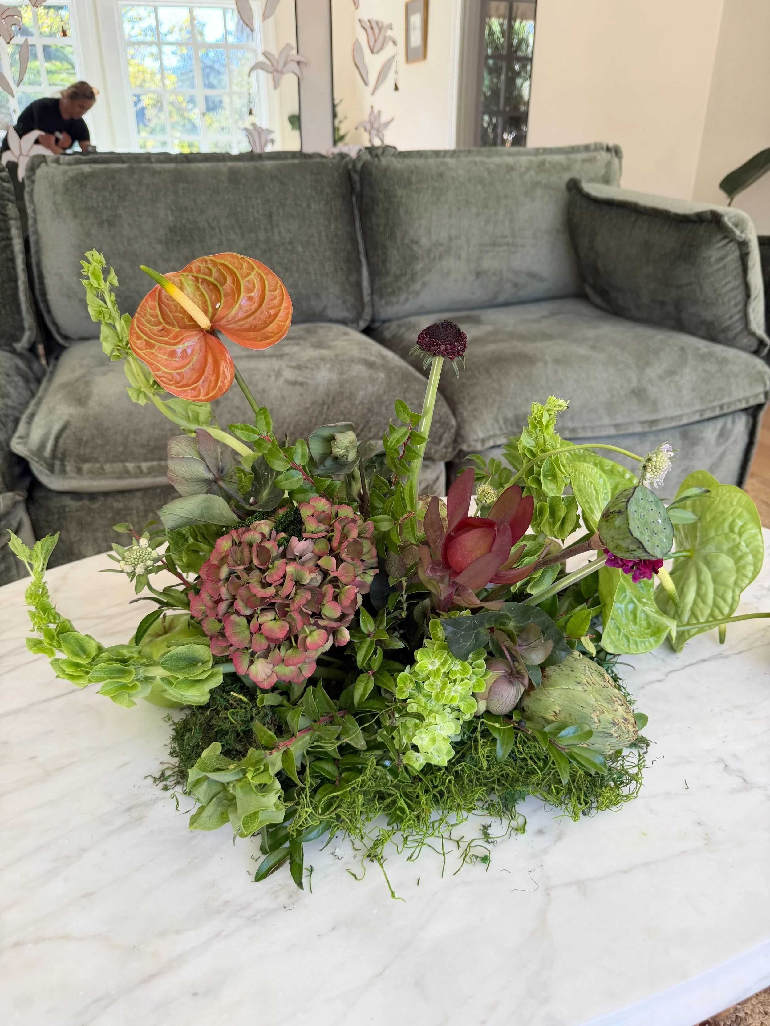 Contemporary corporate event floral design for Methodology, featuring artistic, sculptural arrangements with lush greenery, premium blooms, and unexpected botanical elements. A modern, organic, garden-inspired approach to corporate event florals in S