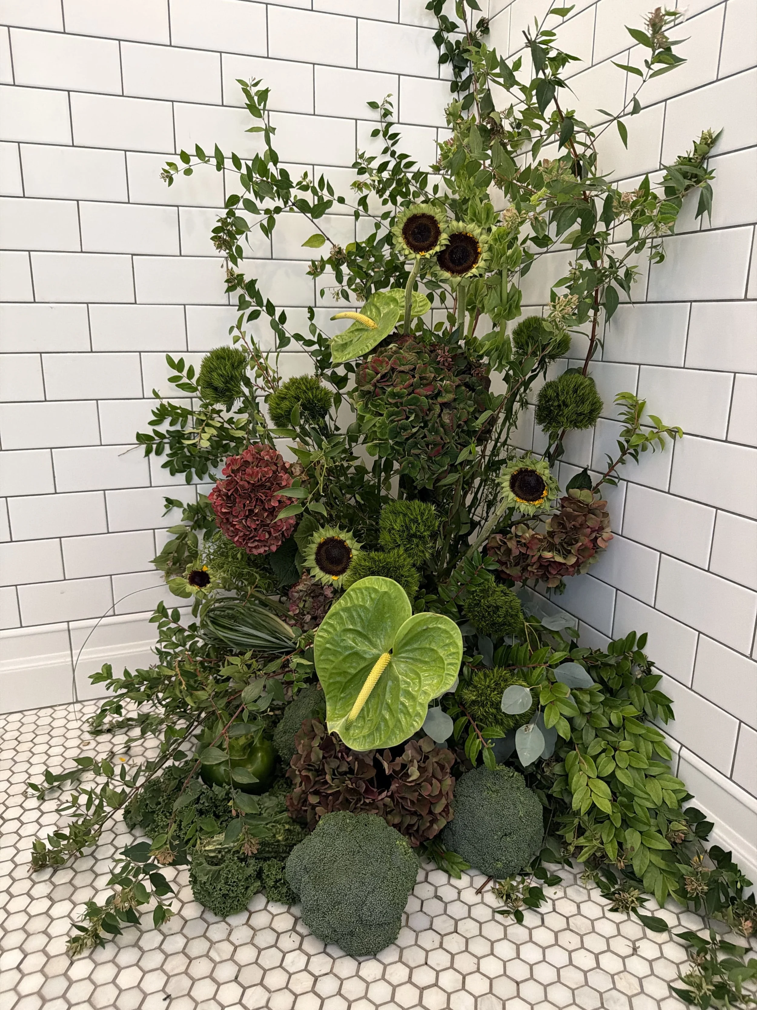 Contemporary corporate event floral design for Methodology, featuring artistic, sculptural arrangements with lush greenery, premium blooms, and unexpected botanical elements. A modern, organic, garden-inspired approach to corporate event florals in S