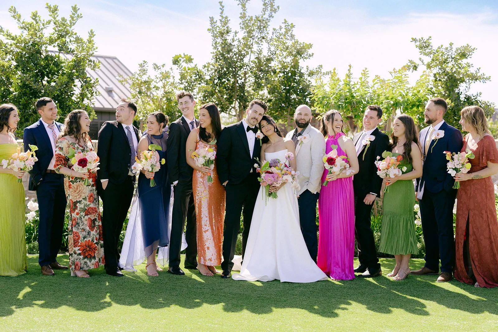 Vibrant Stanly Ranch wedding featuring bold orange, coral, fuchsia, and yellow wedding flowers. Explore lush bridal bouquets, ceremony floral installations, elevated aisle arrangements, and colorful reception centerpieces designed with premium blooms