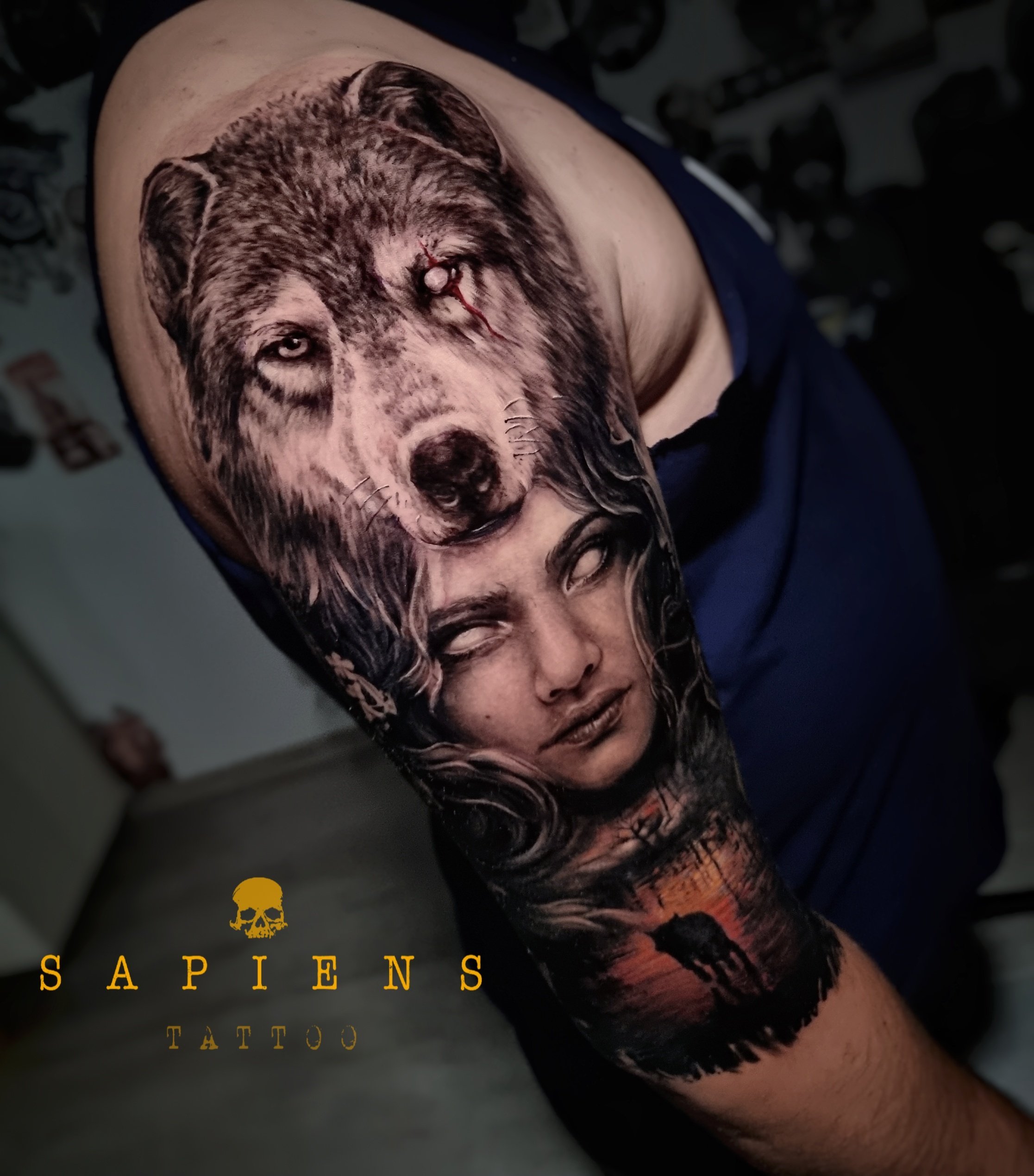 half sleeve tattoo with a woman and ca wolf