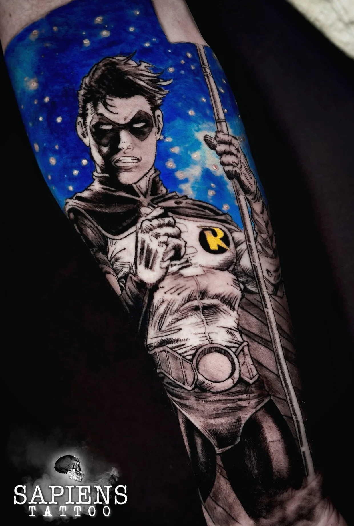full arm tattoo with robin from robin and batman