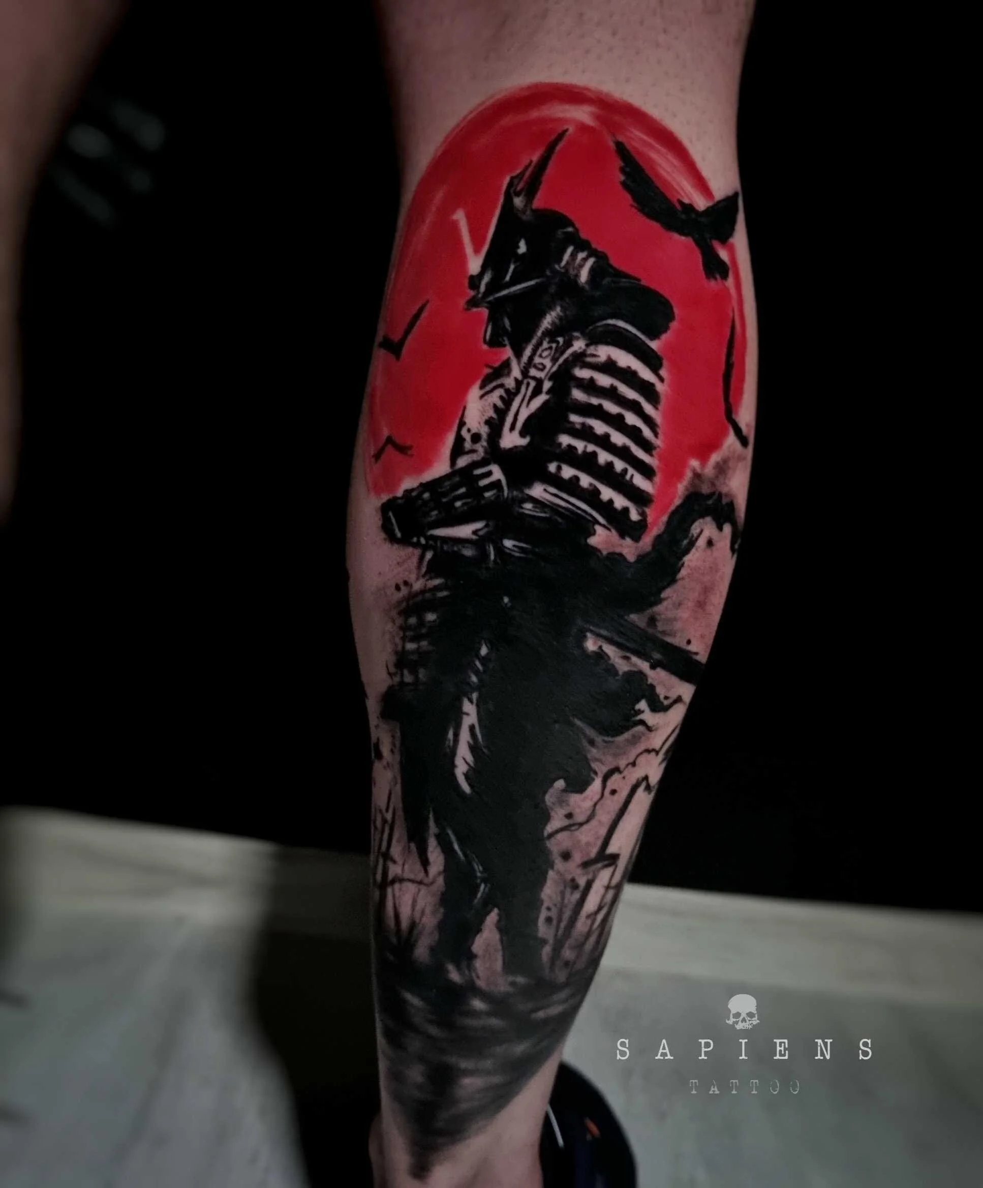 fresh tattoo with samurai on the leg an red ink backround