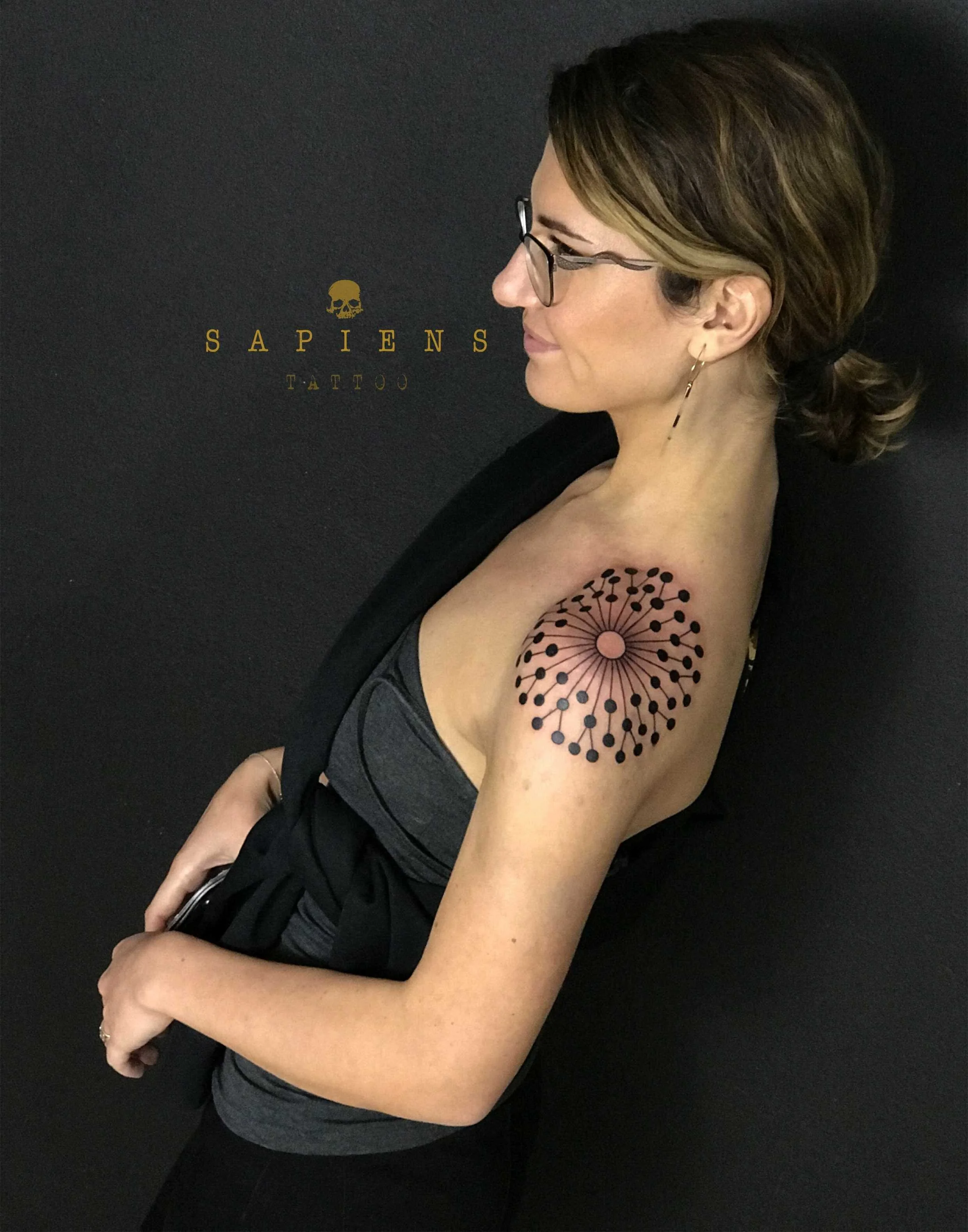geometric tattoo on woman shoulder