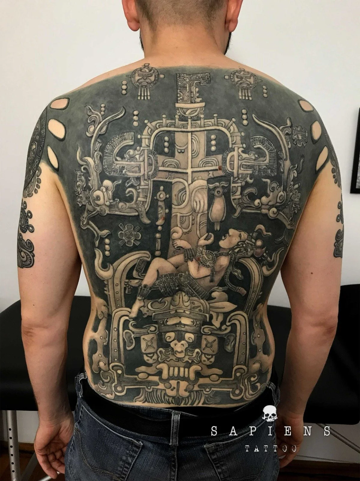 tatuaj pe tot spatele si pe brate cu simboluri mayase