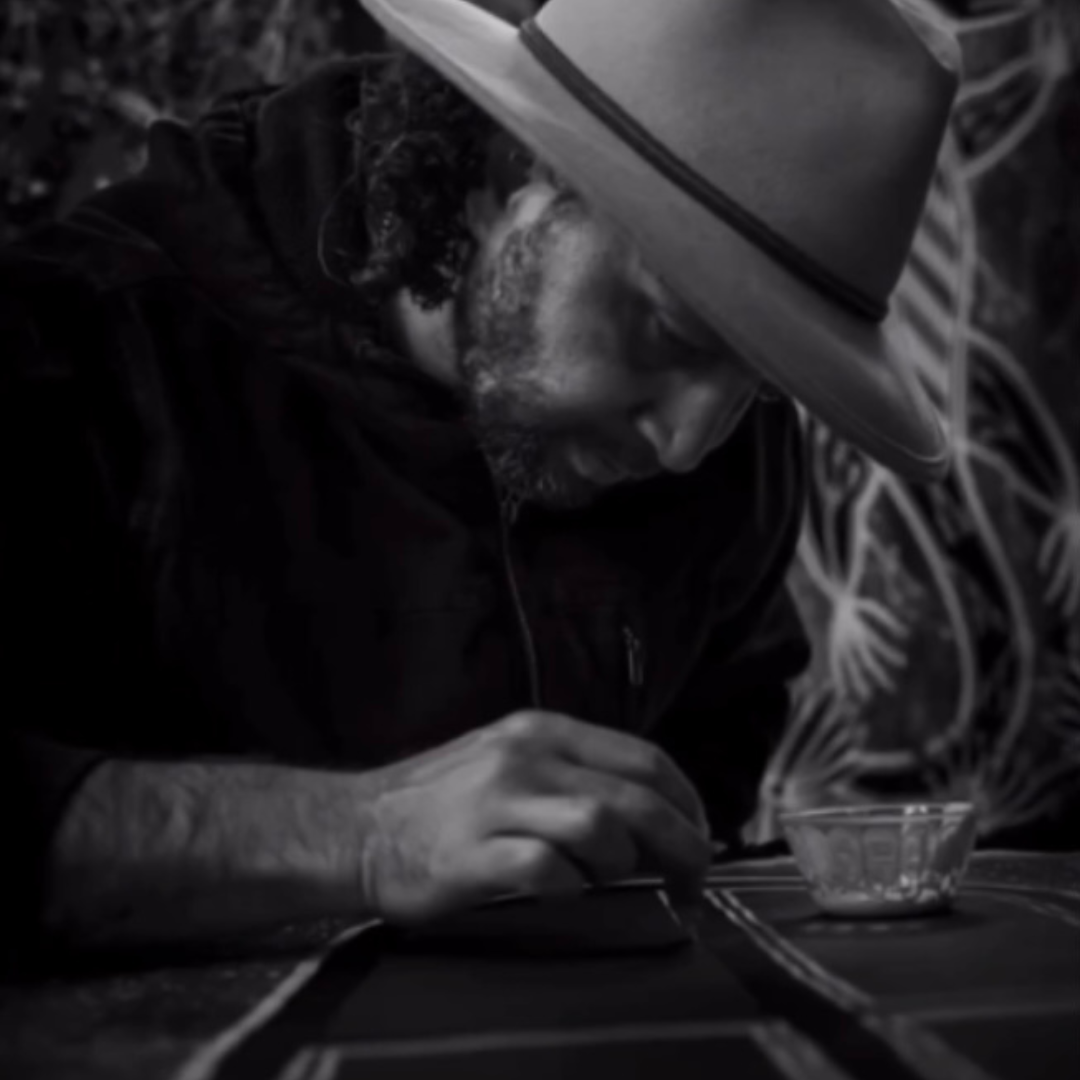 First Nations artist Lyle Ah Sam creating artwork in studio during live art painting in community setting
