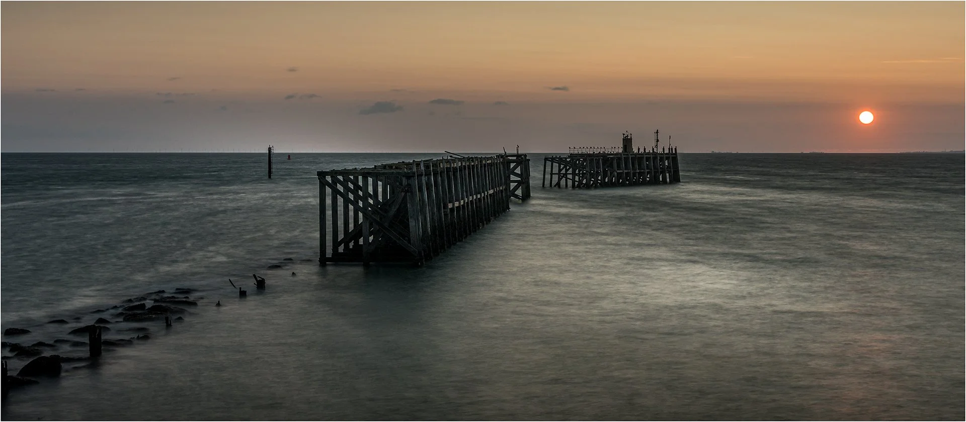 Remnants Of A Pier At Sunset.jpg