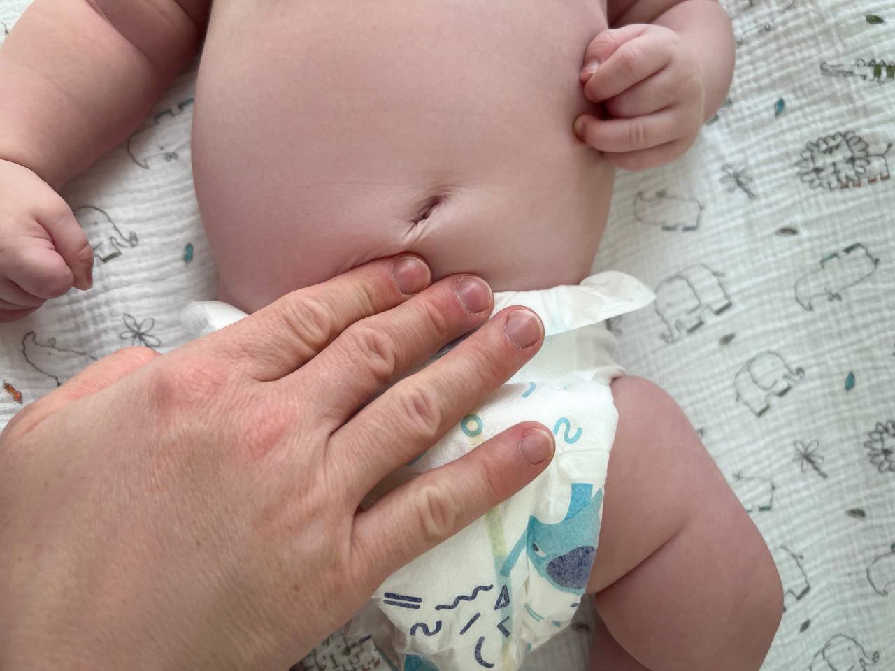 mom massaging a newborn baby.jpg