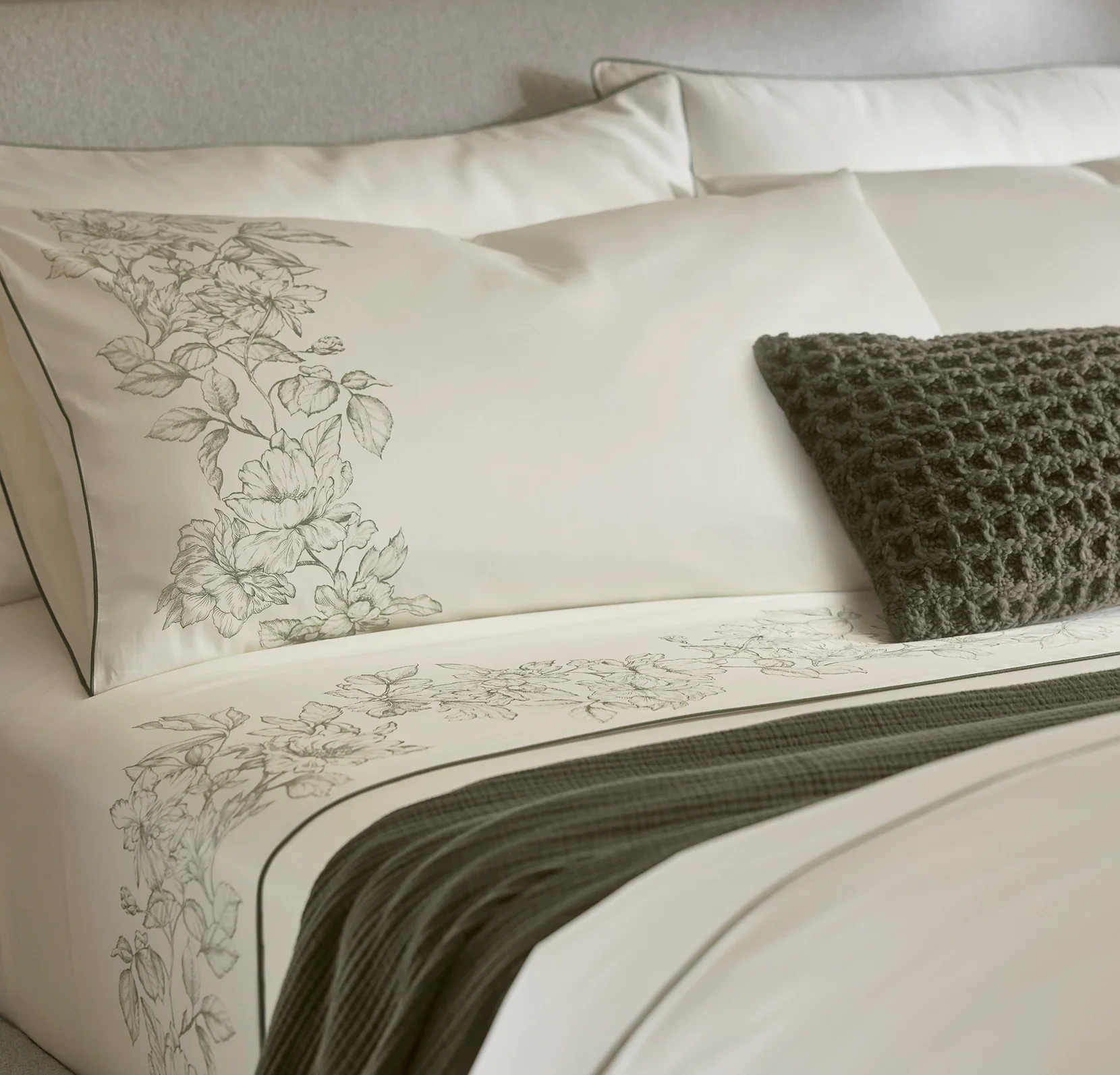 CreamOlivine_EtchedPeony_PipedEdge_SheetSet_PillowDetail_SNYDER_06022025_FINAL.webp