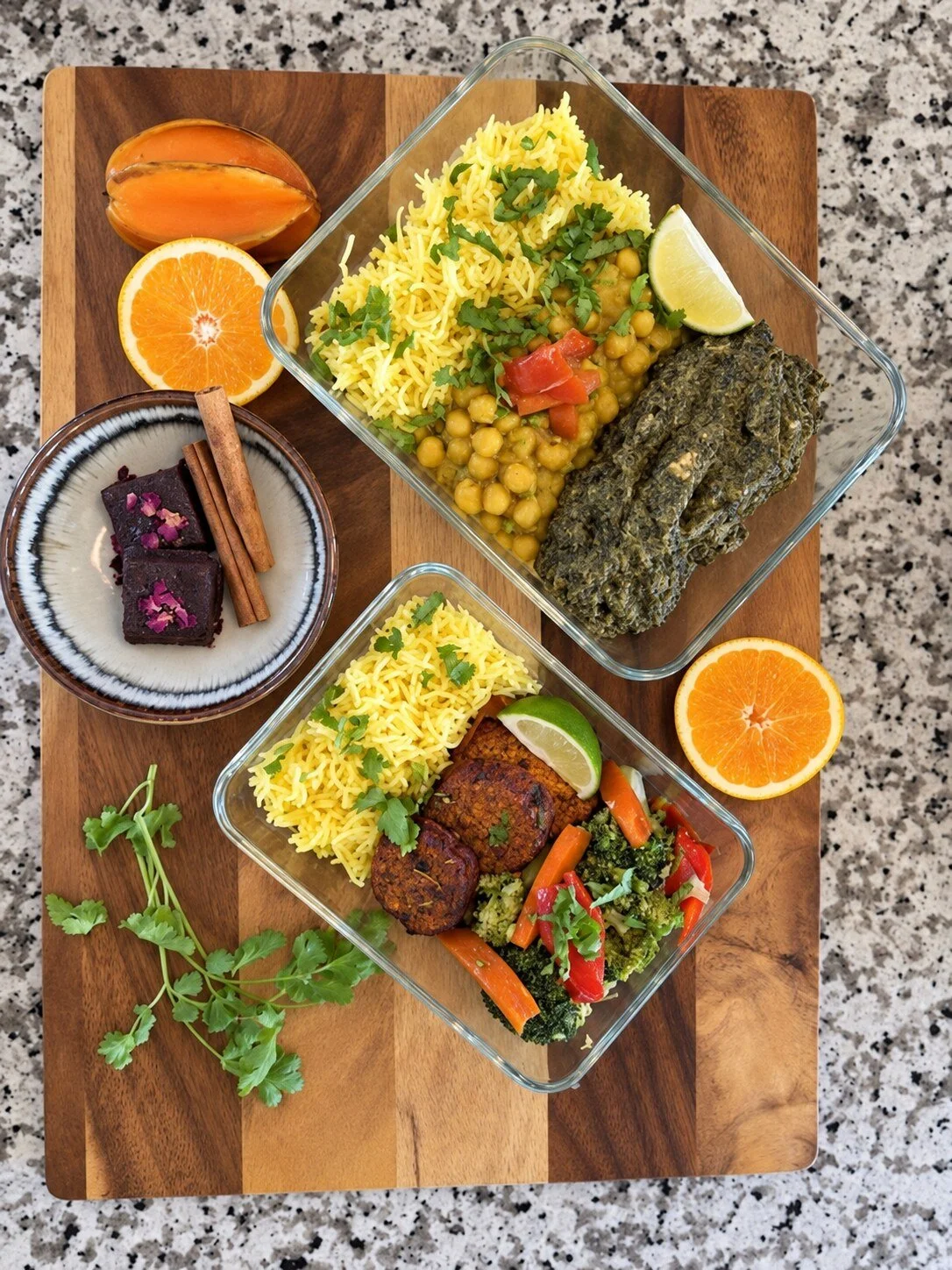 Examples of prepared vegetarian meals for Ayurvedic Renewal, with rice, vegetables, fruit and dessert beside reusable glass meal containers.