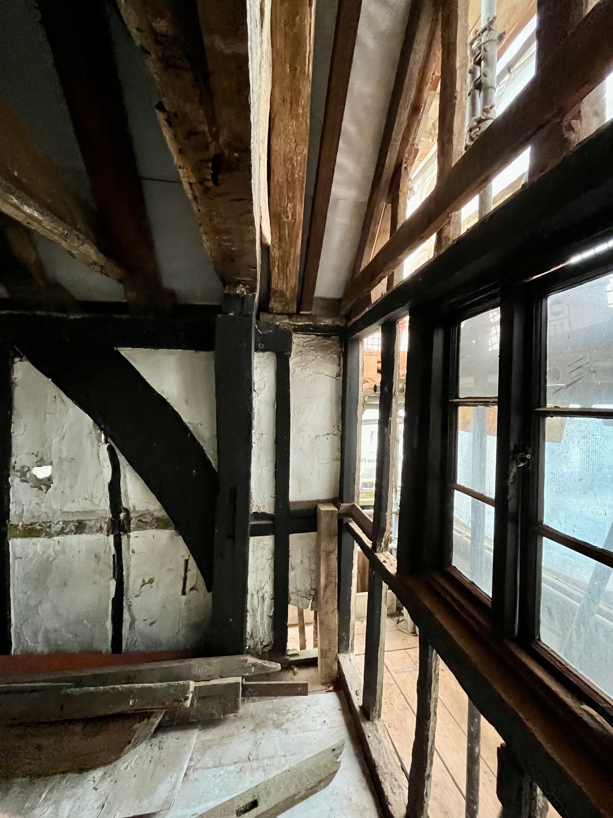 Grade II* listed timber framed building with window, undergoing conservation repair, regeneration, retrofit and conversion to holiday lets.