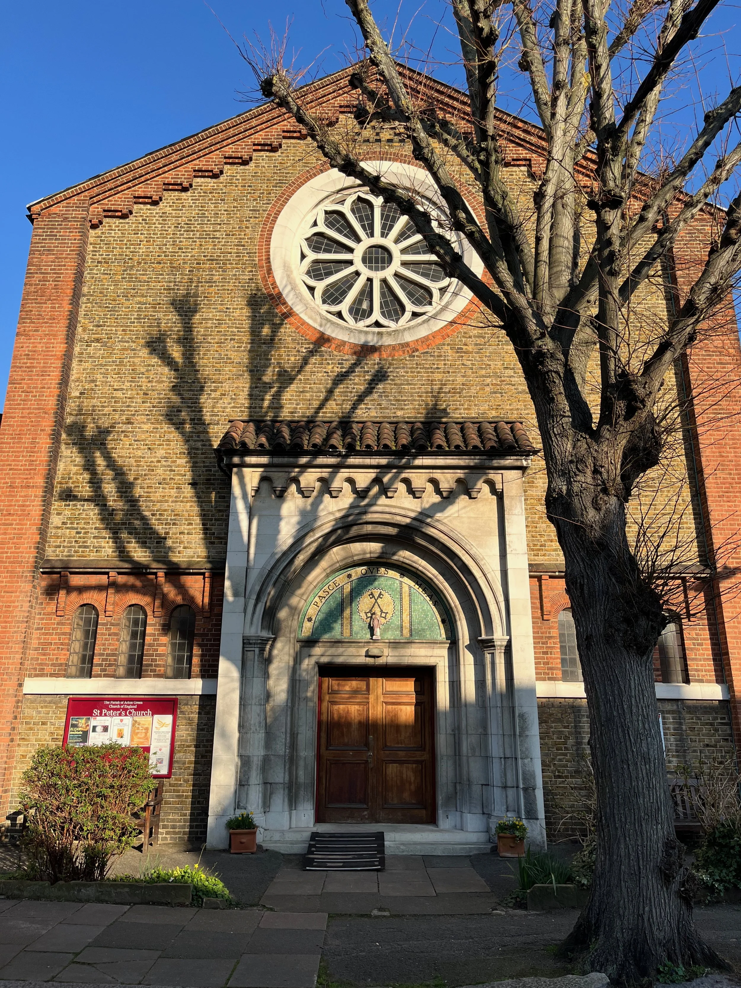 Front elevation of St Peter's Church, Acton Green, a yellow and red brick church where Sarah undertakes the QI inspection and is leading projects for repair, reordering, improving access and creating space.