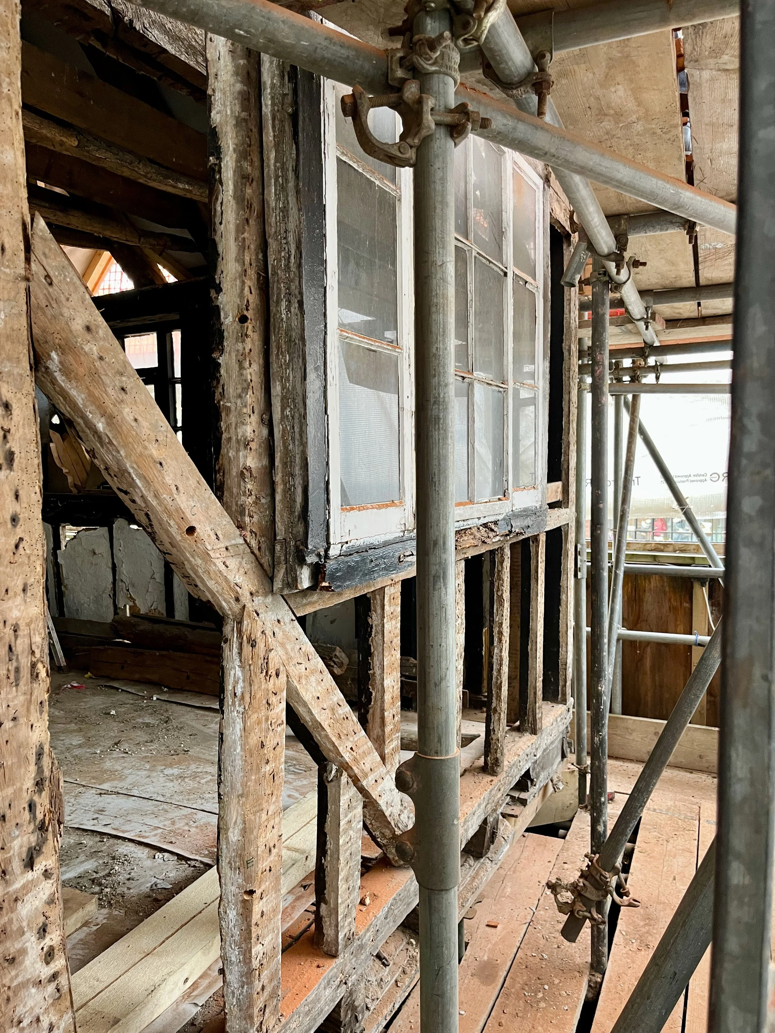 Grade II* listed timber framed building with window, undergoing conservation repair, regeneration, retrofit and conversion.