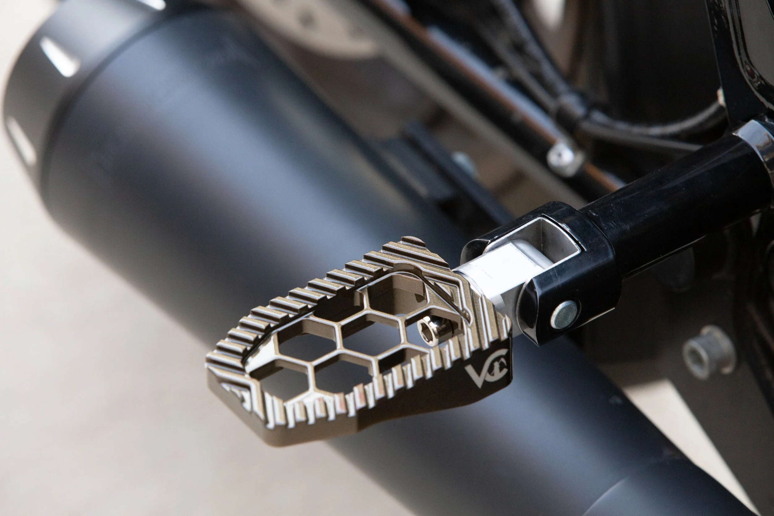 Vengeance Customs passenger footpegs for 2018+ Harley-Davidson Softail in Bronze Bound Finish, installed on motorcycle