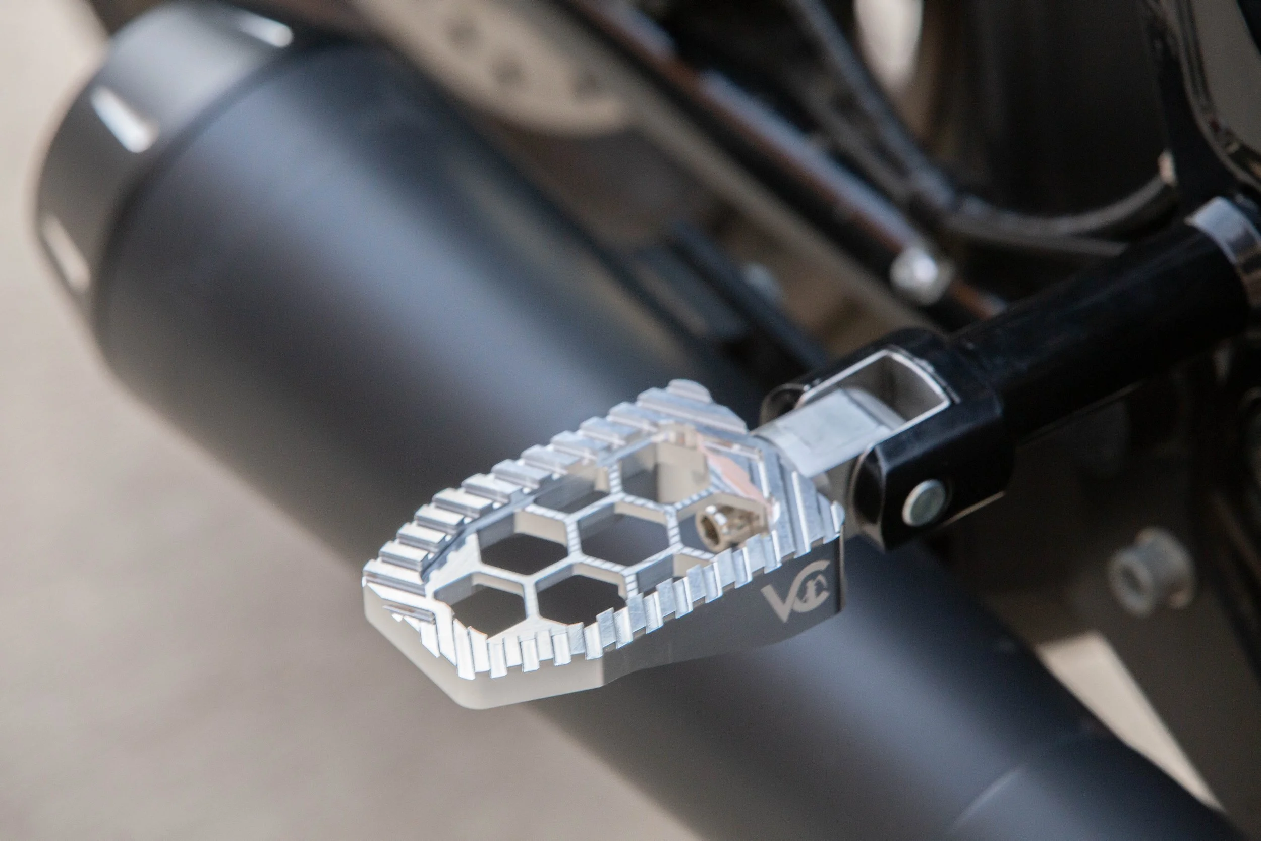 Vengeance Customs passenger footpegs for 2018+ Harley-Davidson Softail in Raw Finish, installed on motorcycle