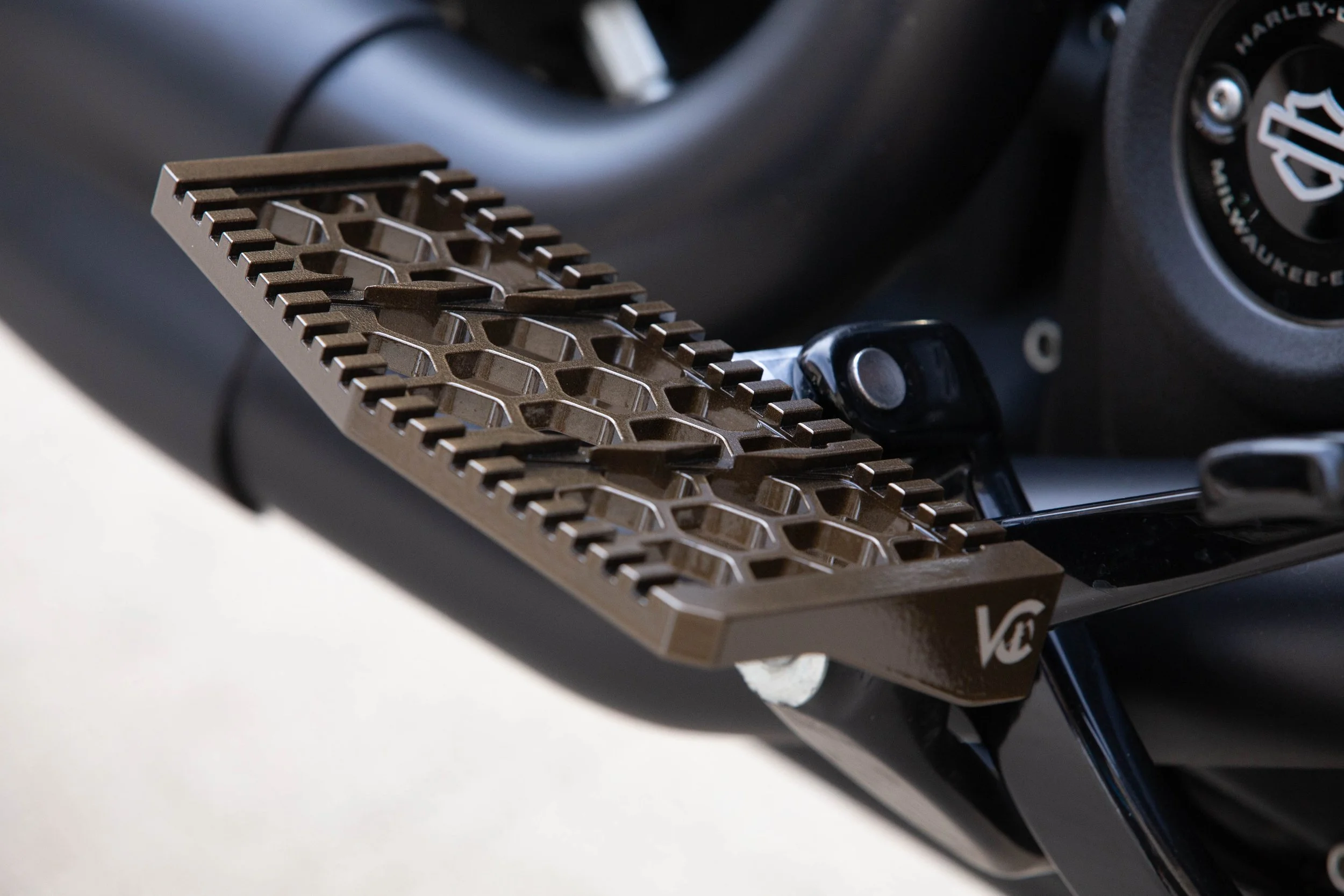 Vengeance Customs rider floorboards for 2018+ Harley-Davidson Softail in Bronze Bound Finish, installed on motorcycle