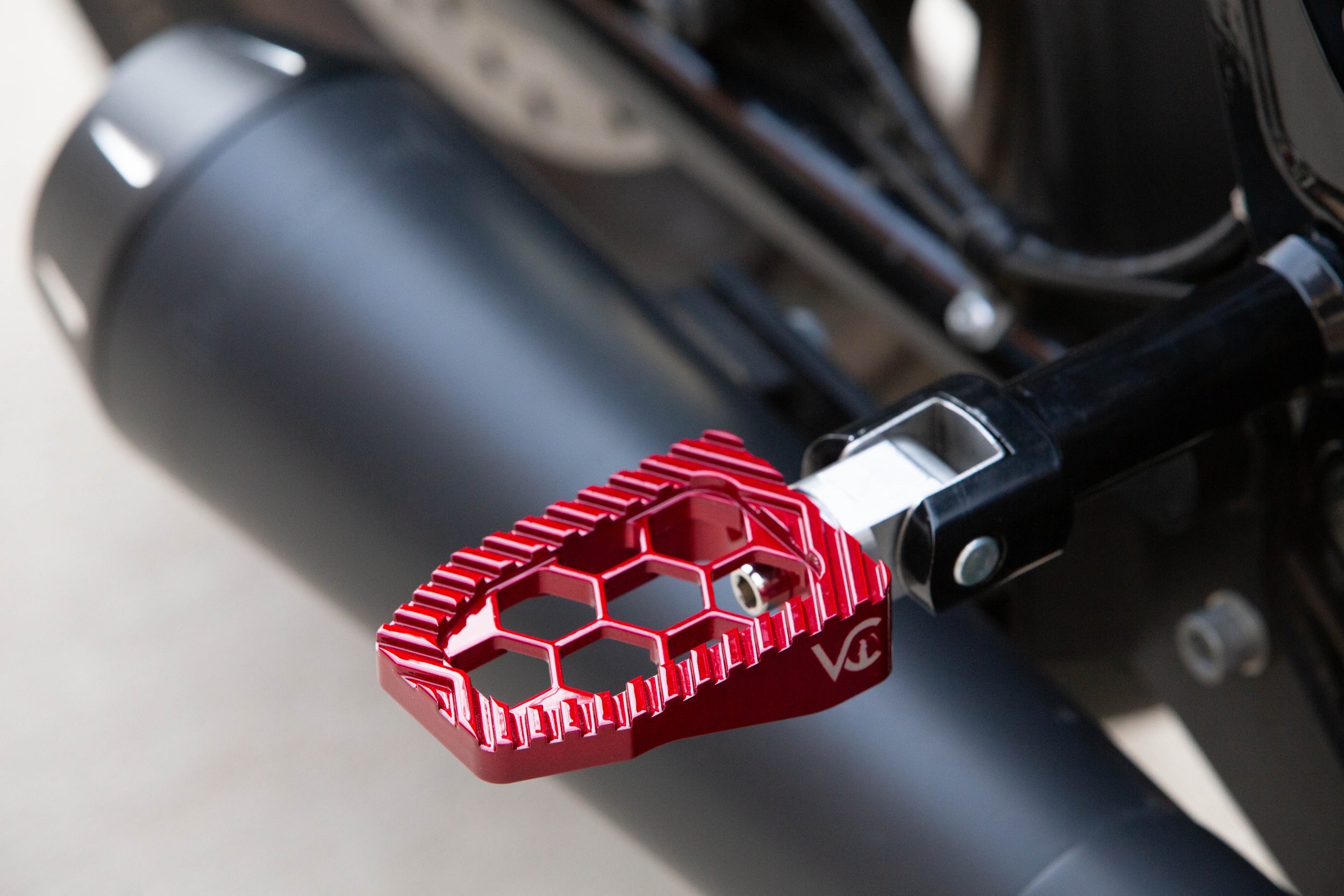 Vengeance Customs passenger footpegs for 2018+ Harley-Davidson Softail in Red Ritual Finish, installed on motorcycle