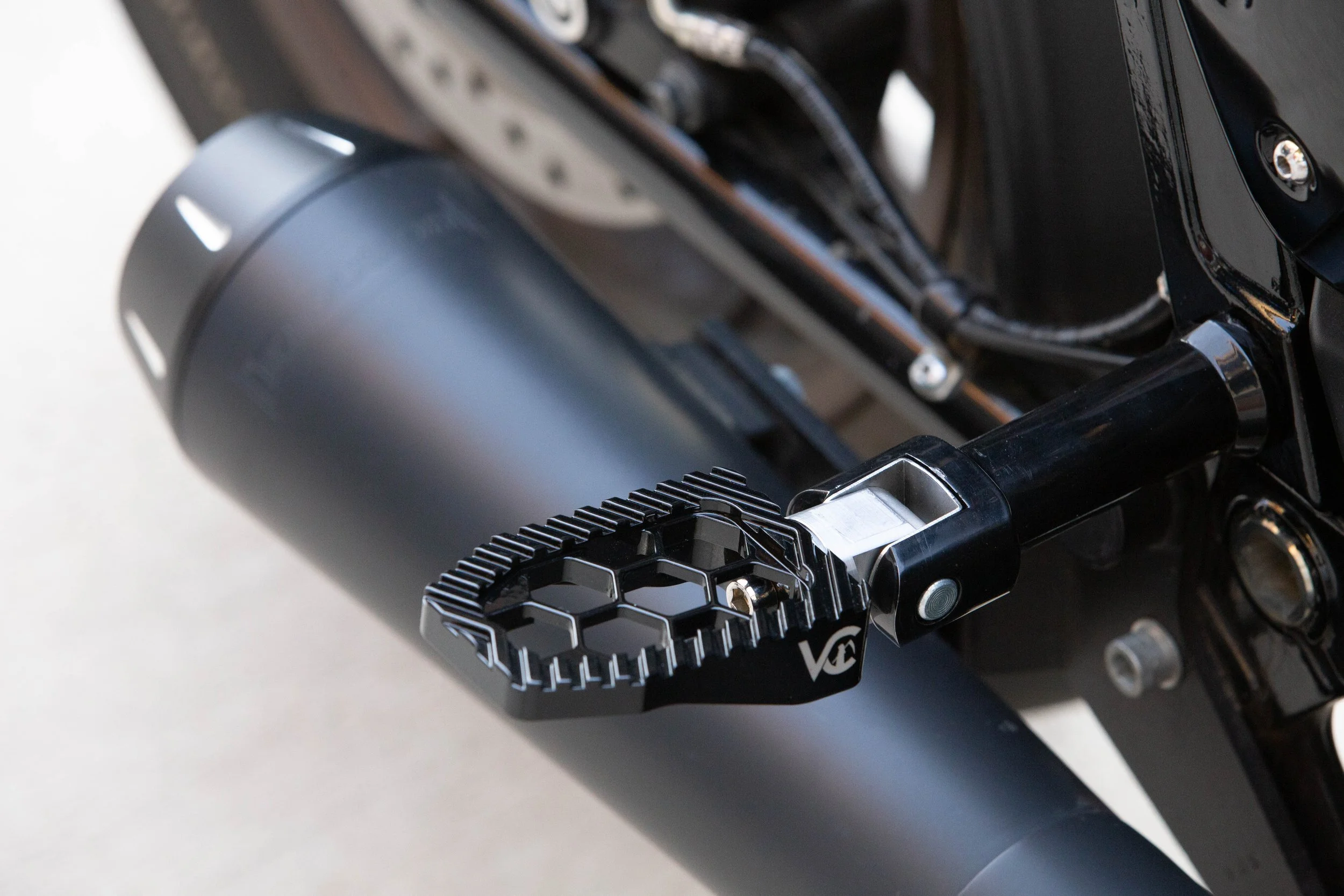 Vengeance Customs passenger footpegs for 2018+ Harley-Davidson Softail in Black Eclipse, installed on motorcycle