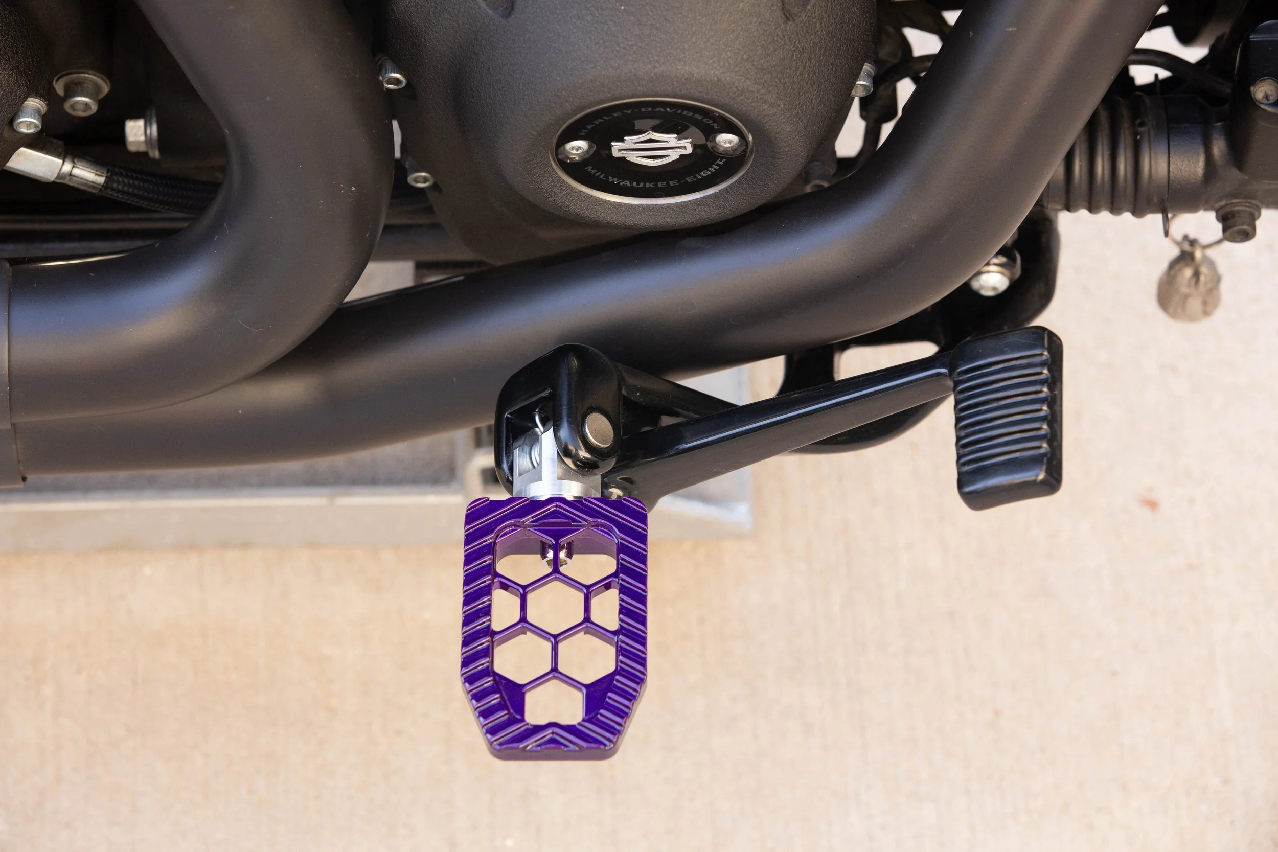 Vengeance Customs rider footpegs for 2018+ Harley-Davidson Softail in Purple Oblivion Finish, installed on motorcycle