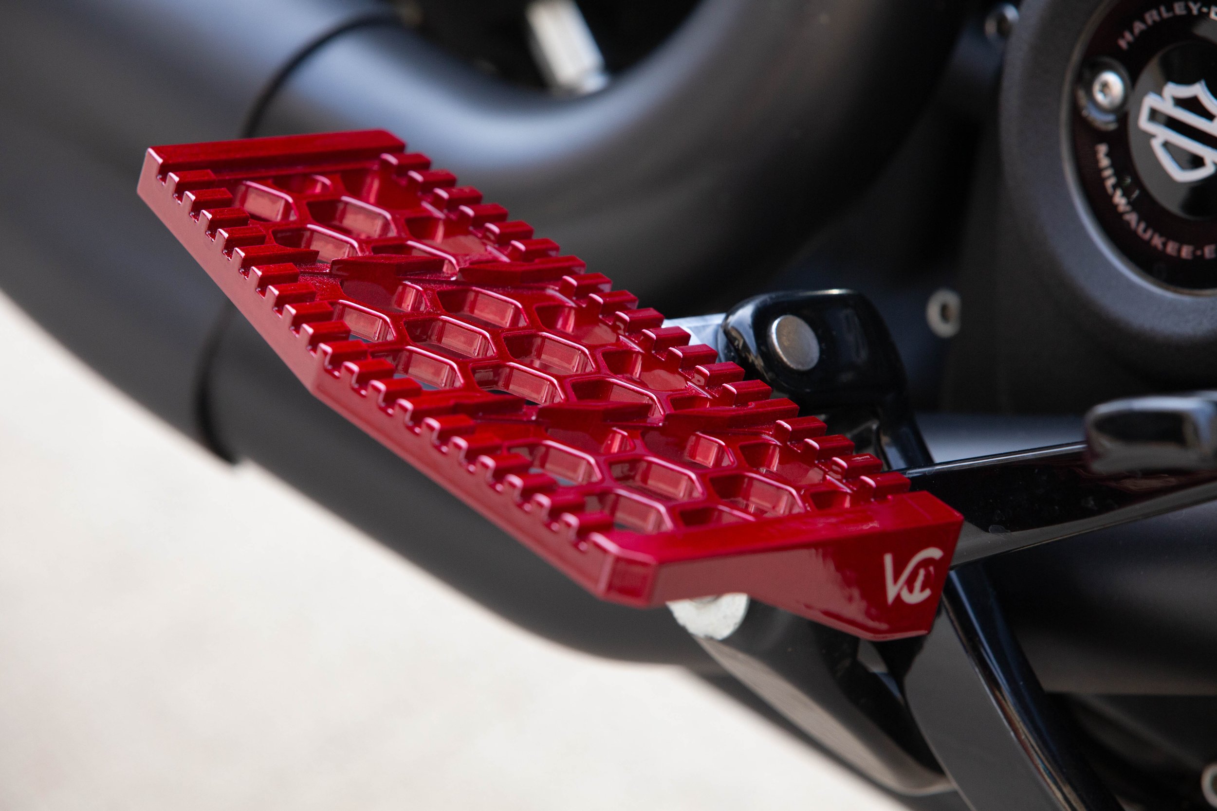 Vengeance Customs rider floorboards for 2018+ Harley-Davidson Softail in Red Ritual Finish, installed on motorcycle