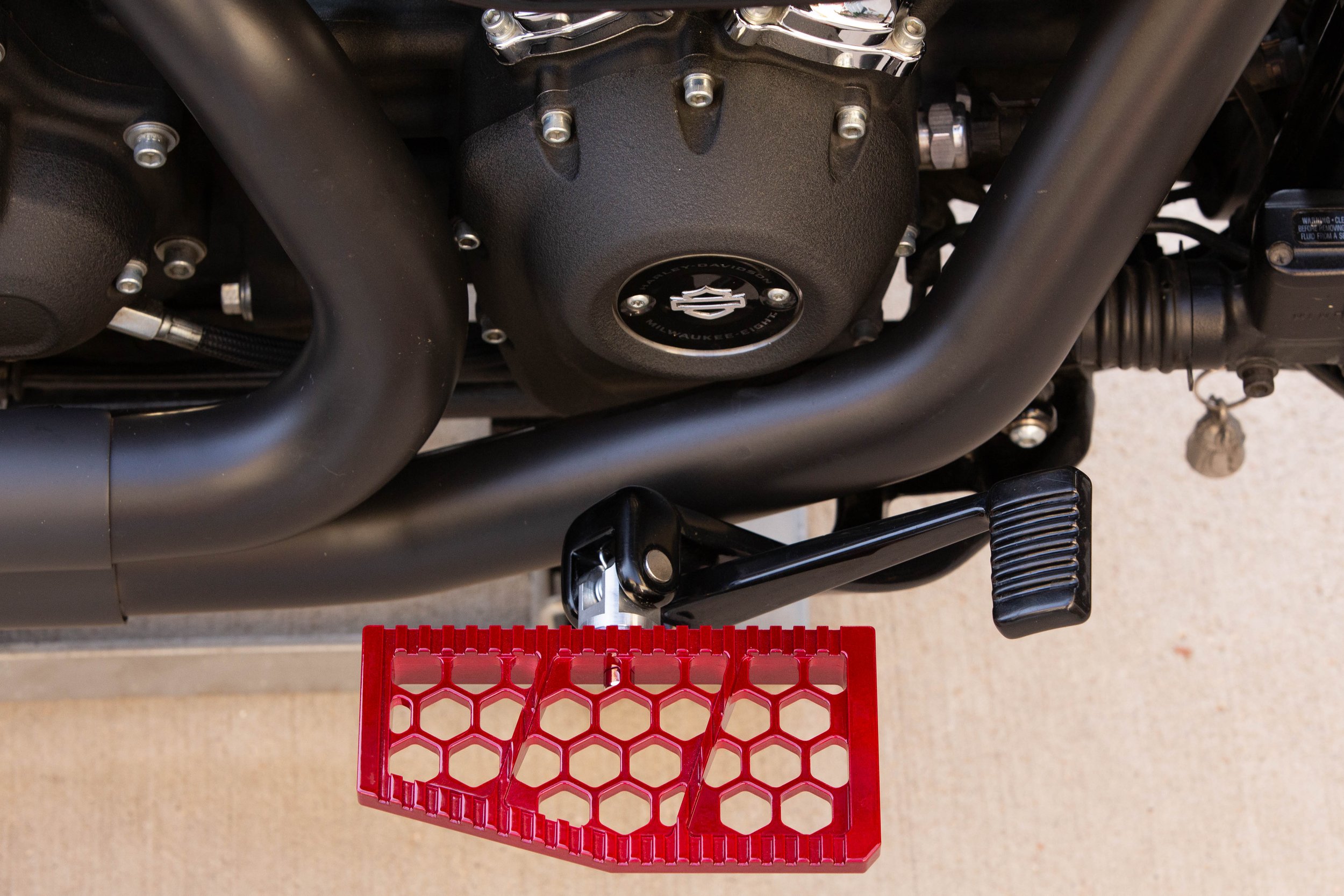 Vengeance Customs rider floorboards for 2018+ Harley-Davidson Softail in Red Ritual Finish, installed on motorcycle