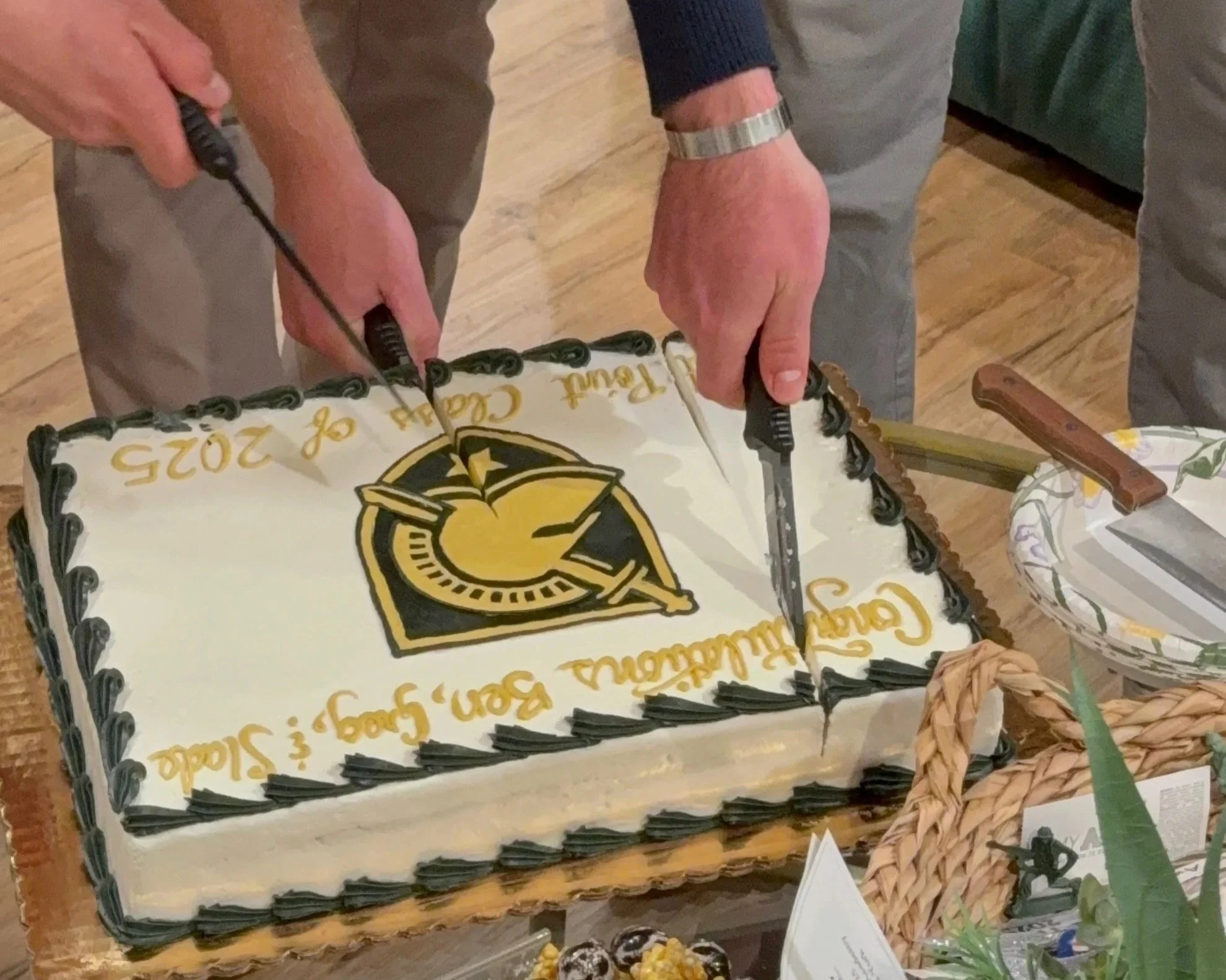 Class of 2025 Firsties using their knives after Graduation