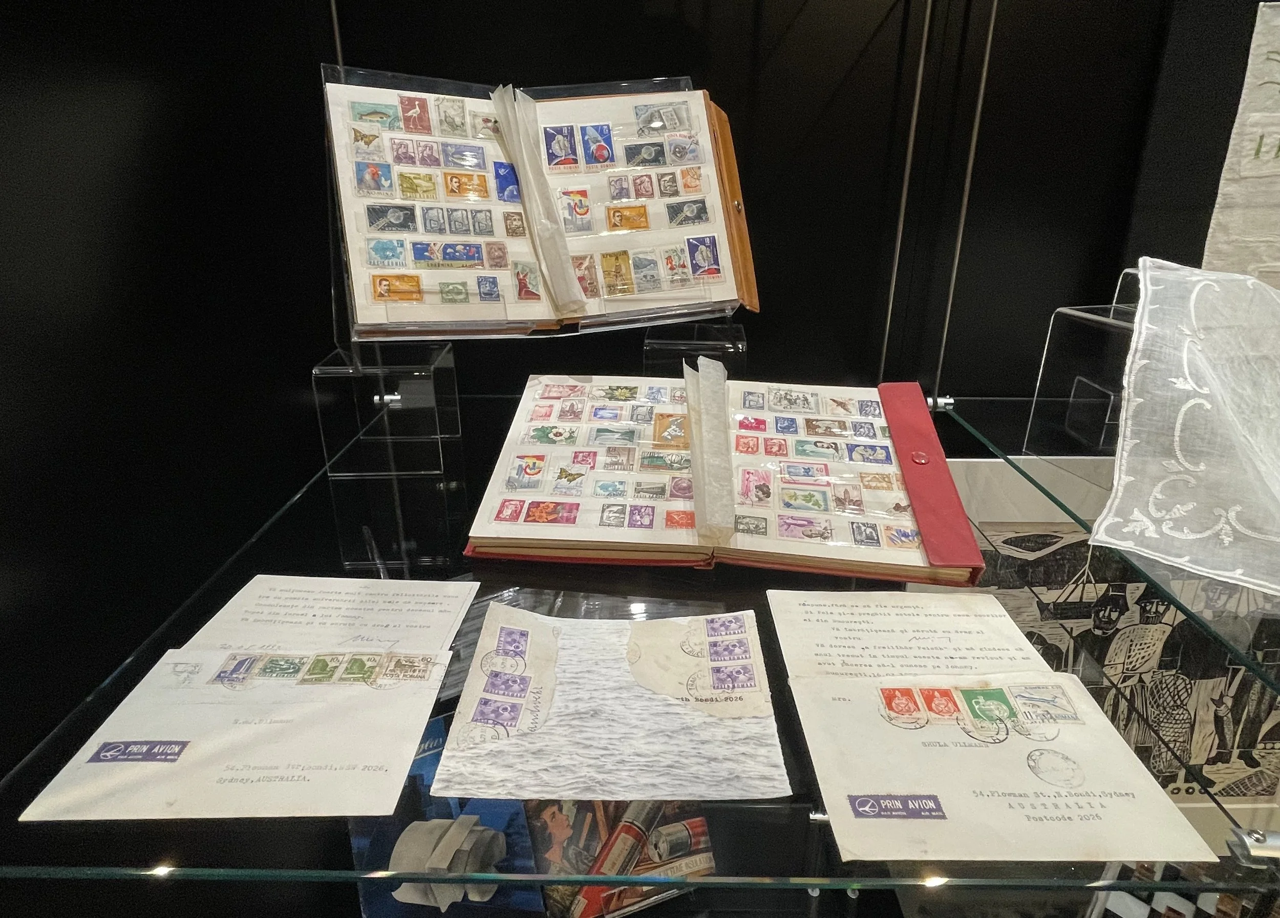 Curiosity cabinet with family stamp albums and inherited letters, collage by Naomi Ullmann